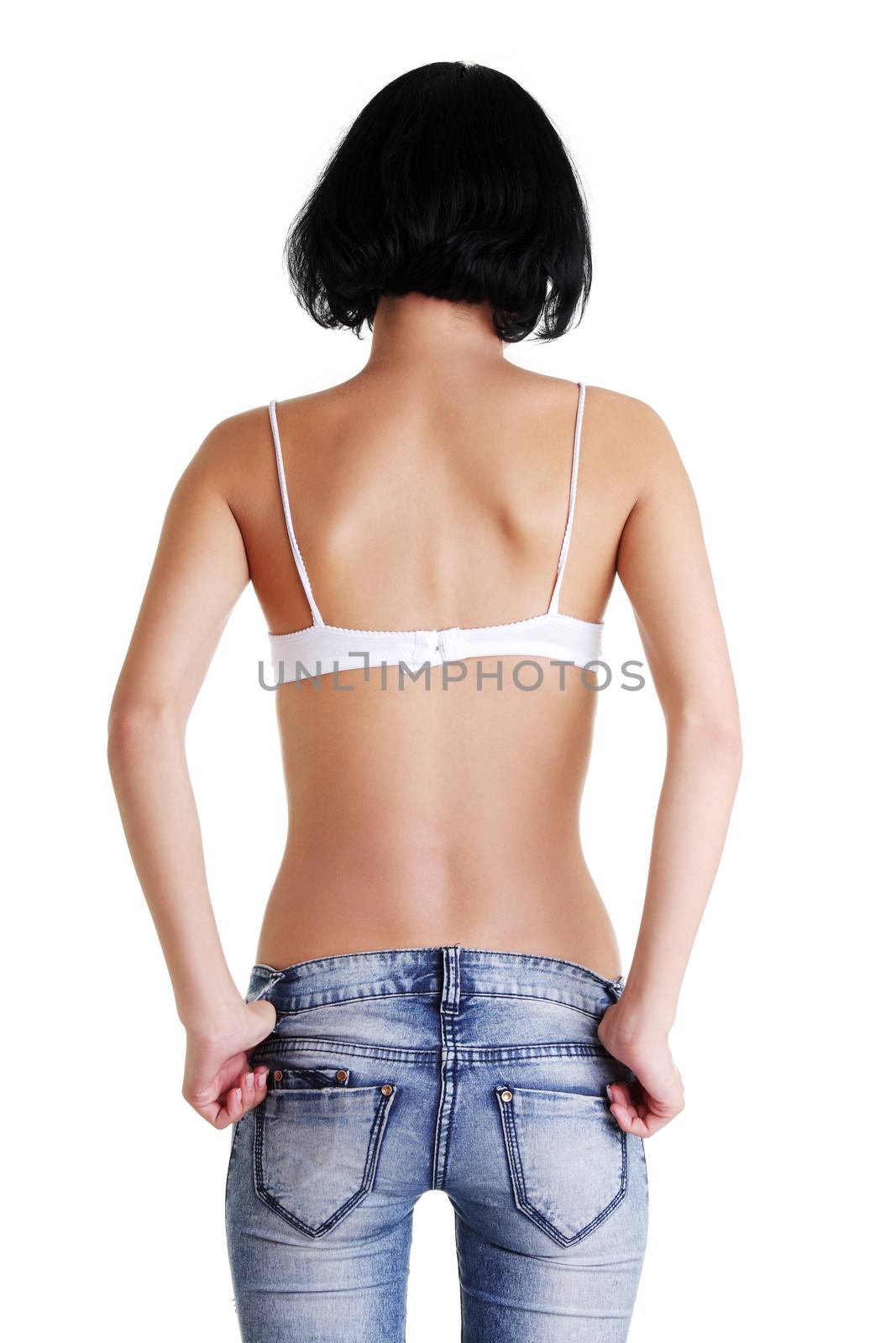Rear view of fit female in blue jeans by BDS