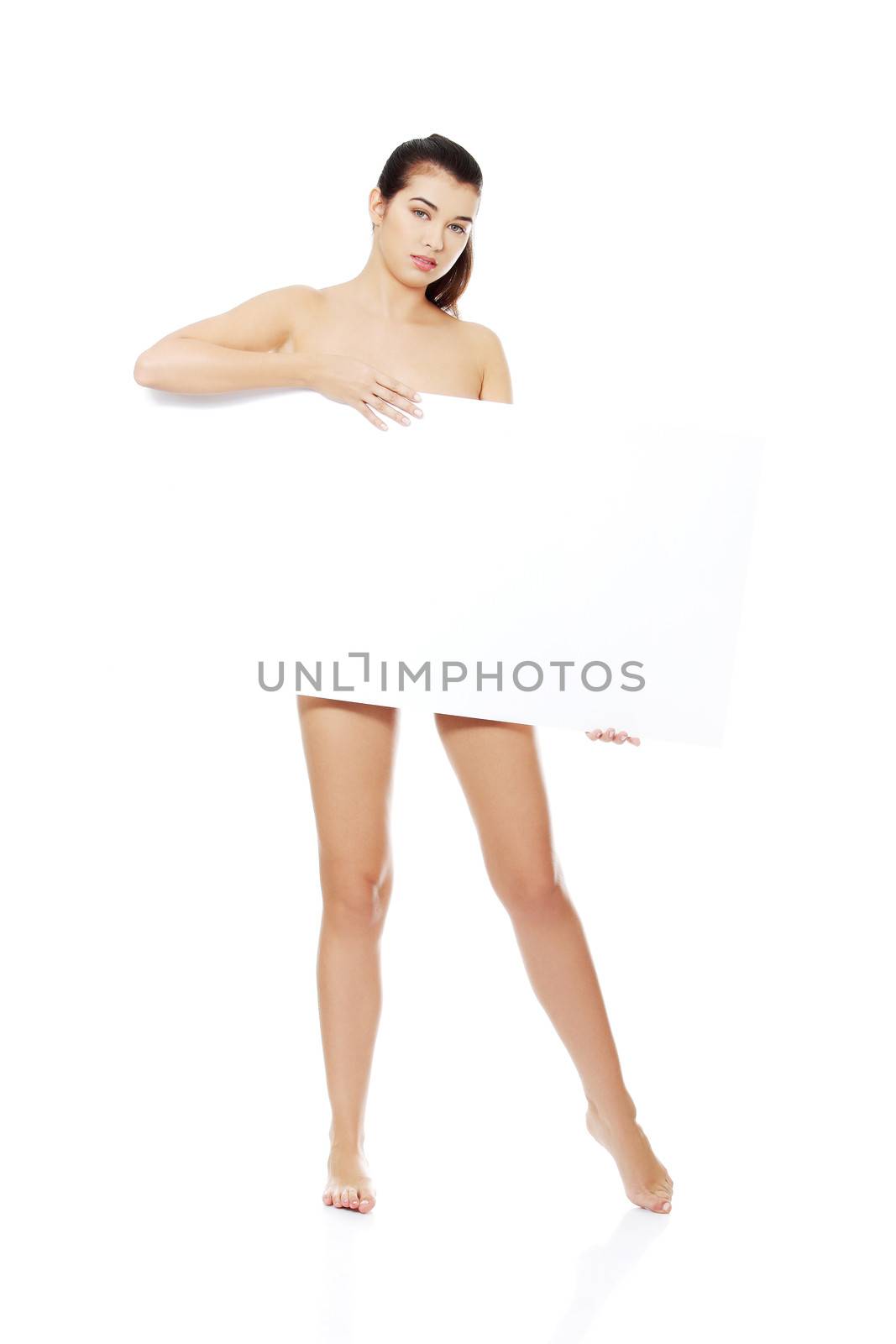 Sexy naked brunette holding empty board , isolated on white.