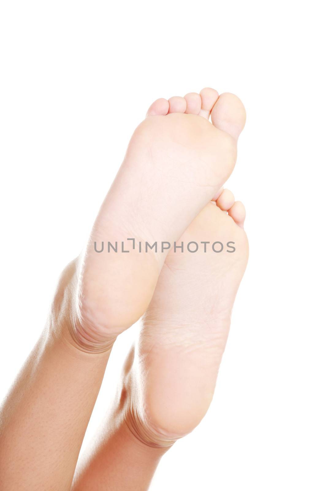 Beautiful female a foot and a heel lifted upwards on a white background