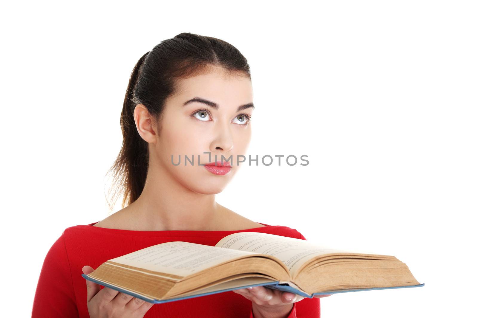 Young woman reading an old book, isolated on white