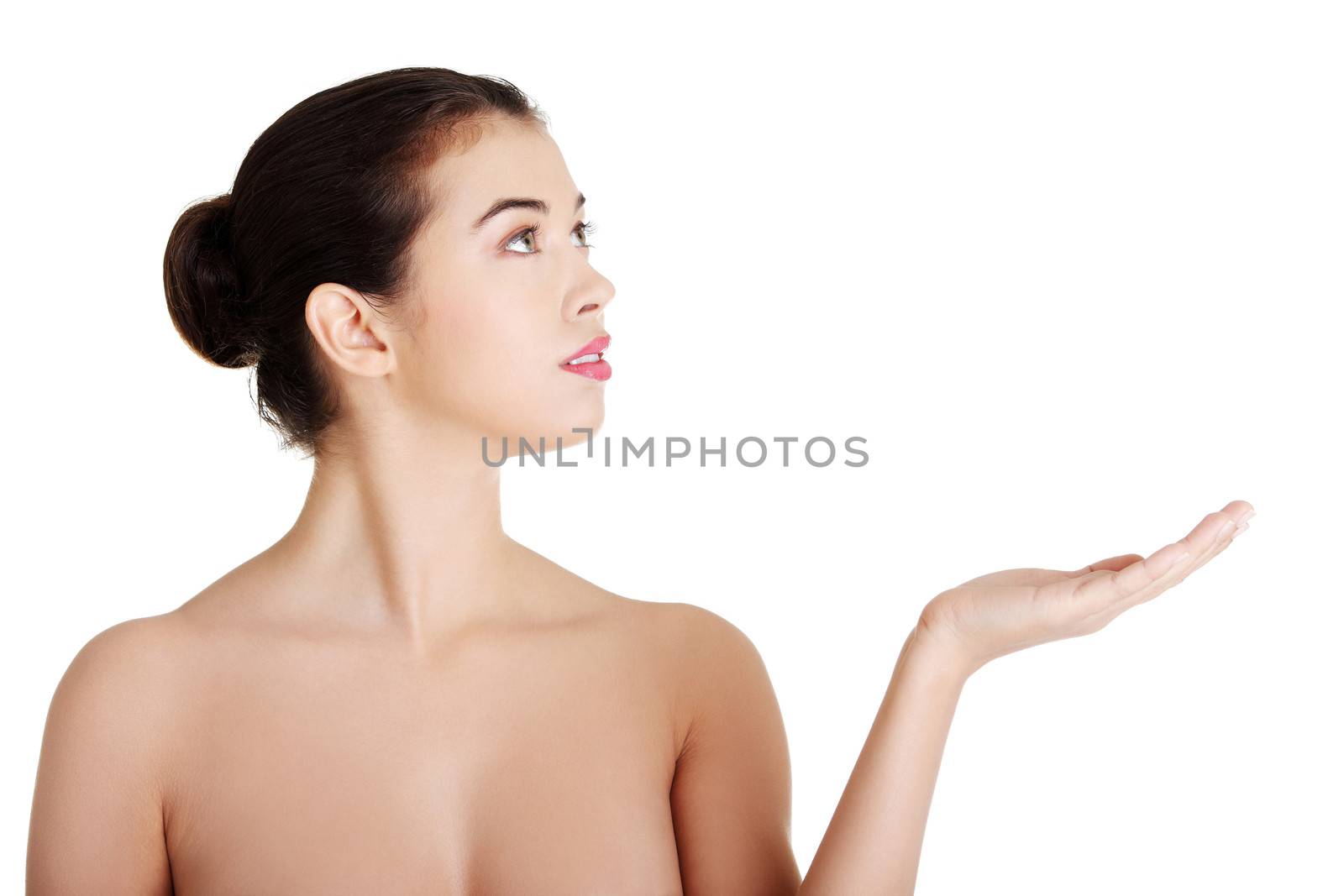 Attractive woman with clean fresh skin presenting copy space on her palm