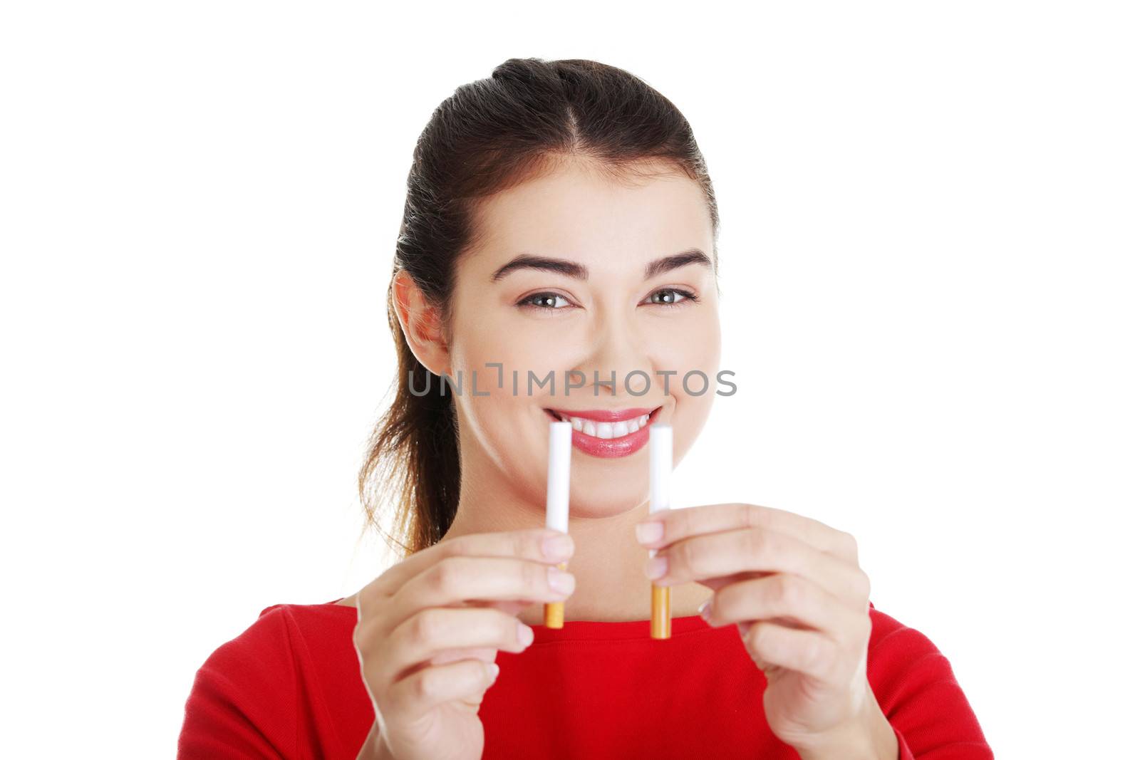 Young woman holding in one hand classic cigarette and in other electronic cigarette