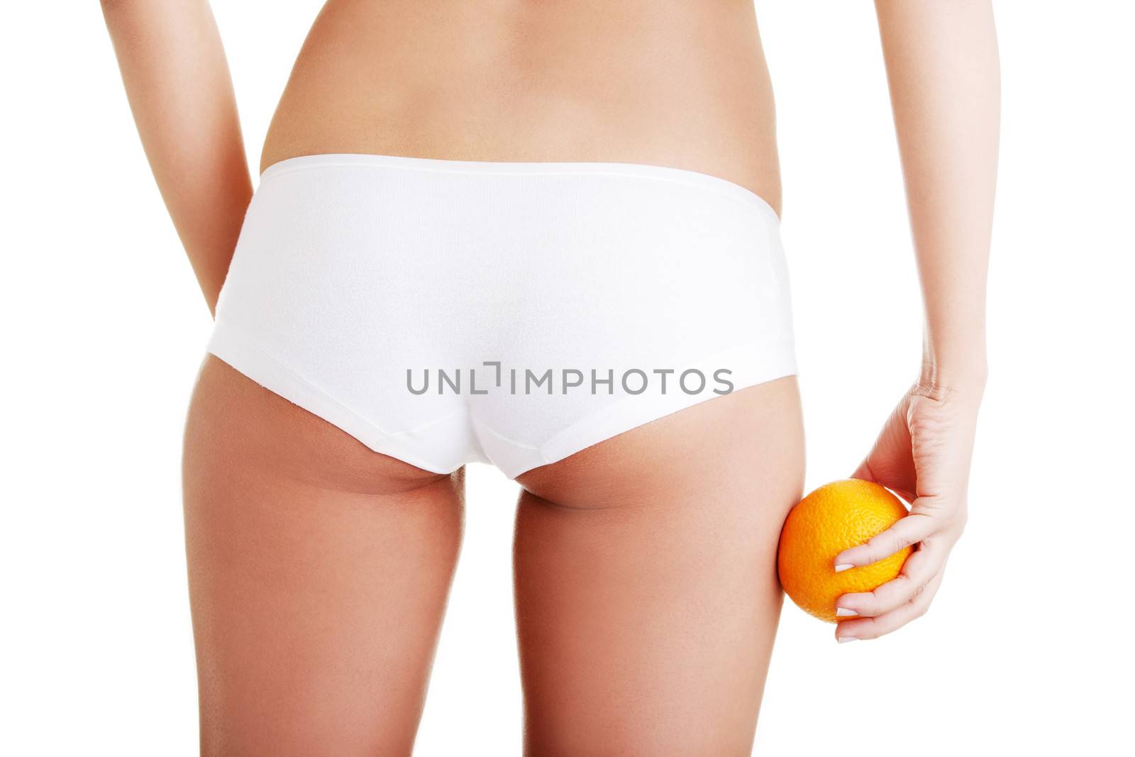 Hip, legs, abdomen and orange in hand. Cellulite, liposuction ,woman weight loss control concept