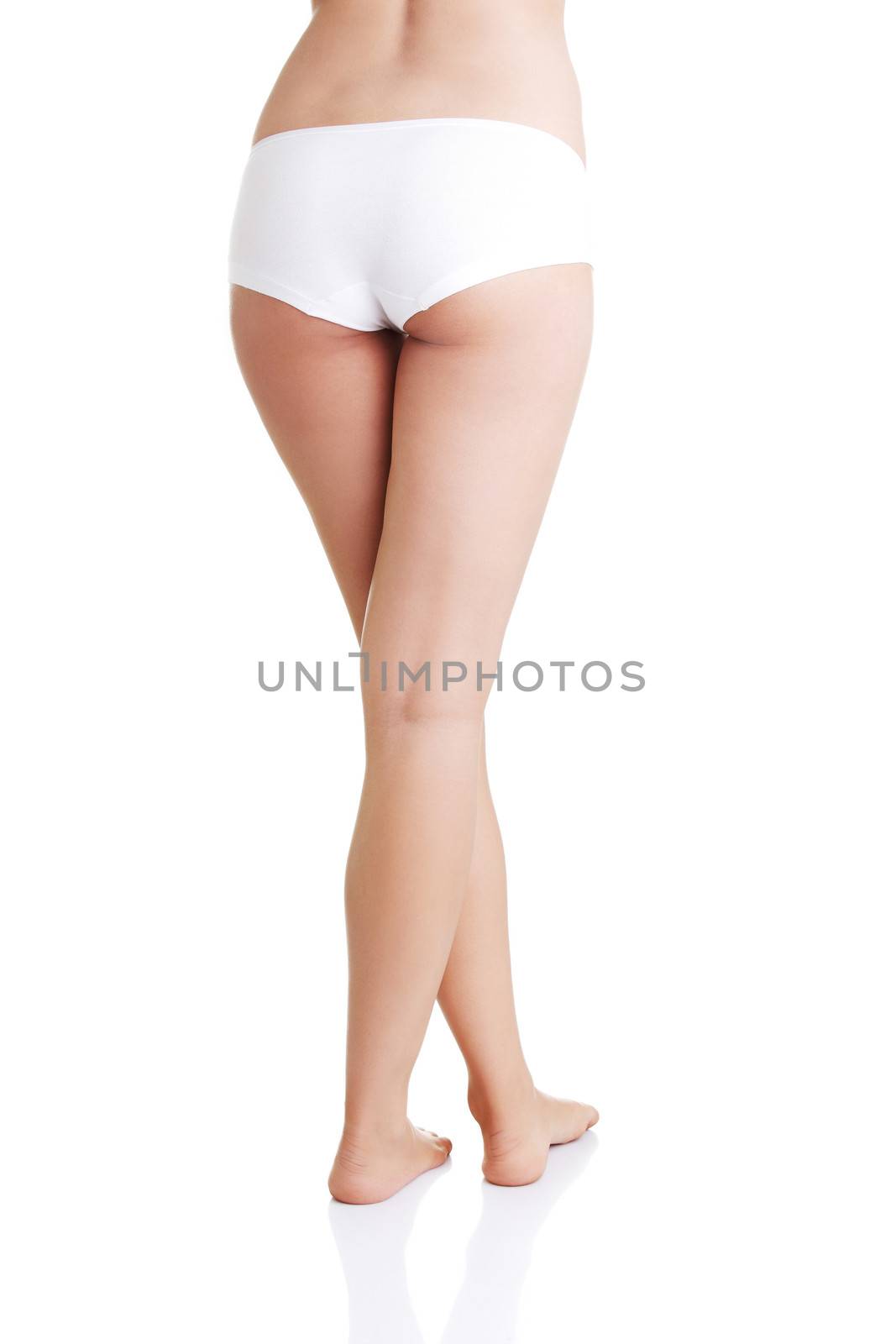 Slim tanned woman's body in black panties. Isolated over white background.