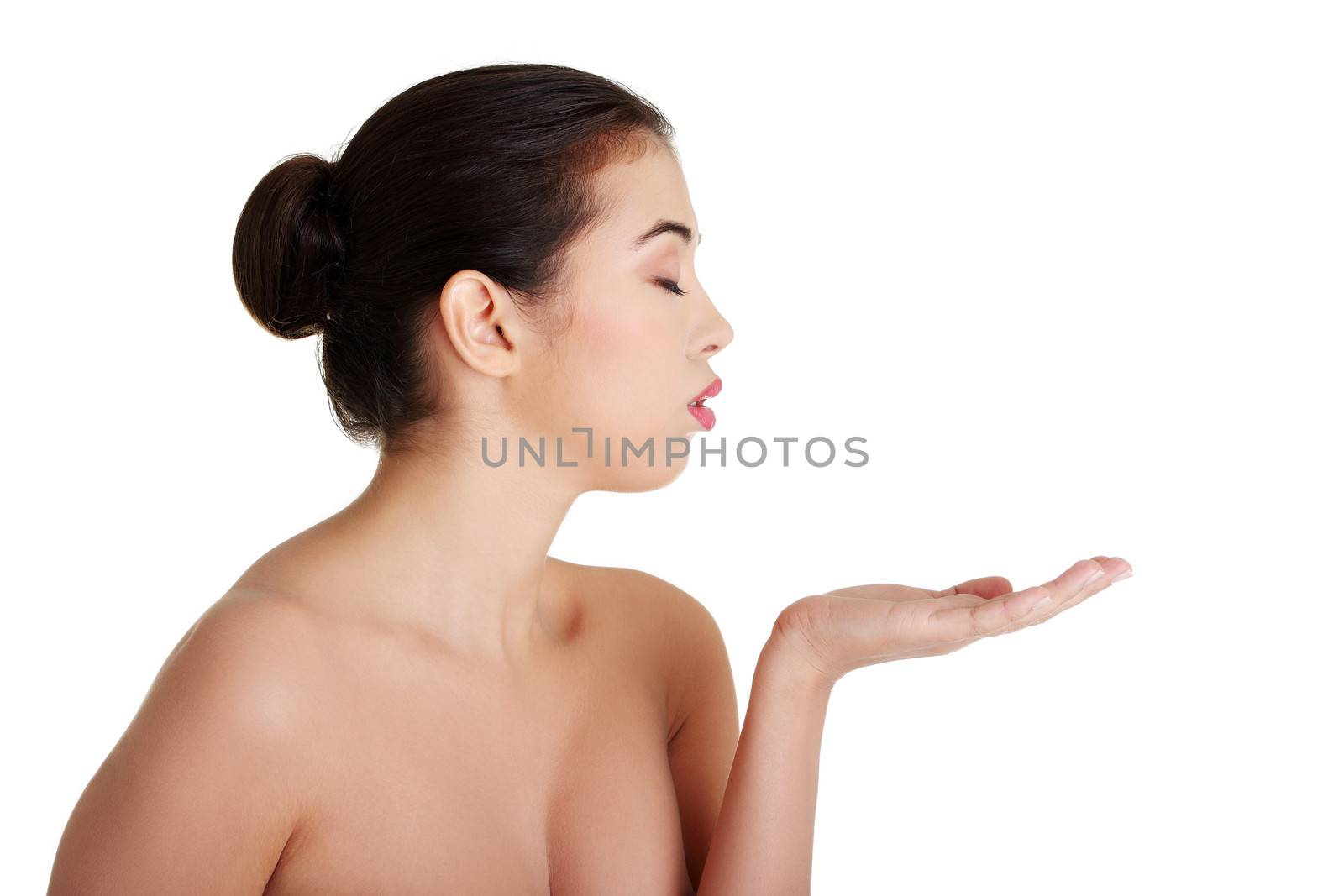 Attractive woman with clean fresh skin presenting copy space on her palm