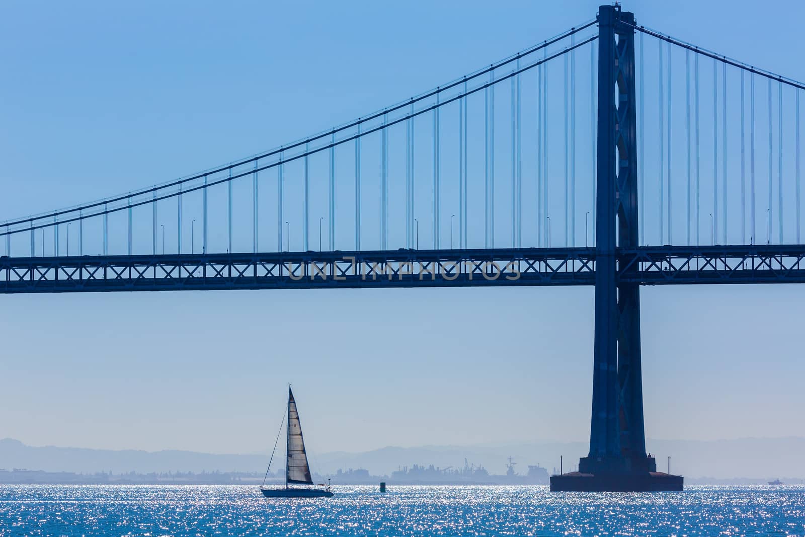 San Francisco Bay bridge sailboat from Pier 7 in California USA