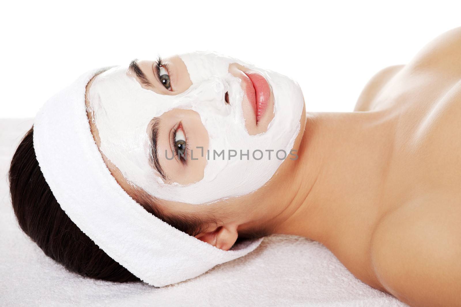 Beautiful woman with clay facial mask by BDS
