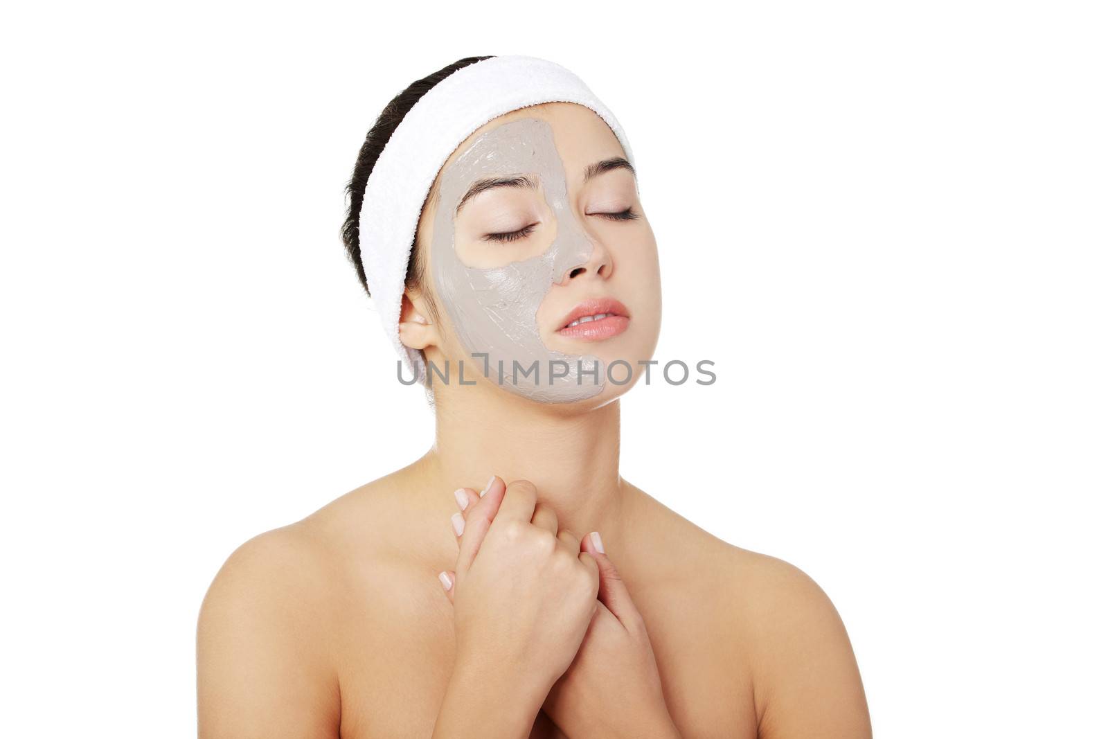 Beautiful woman with clay facial mask, isolated on white