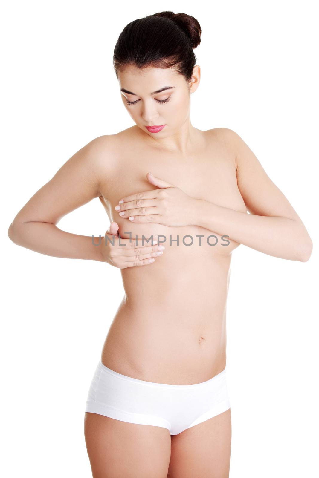 Woman examining breast mastopathy or cancer. Isolated on white