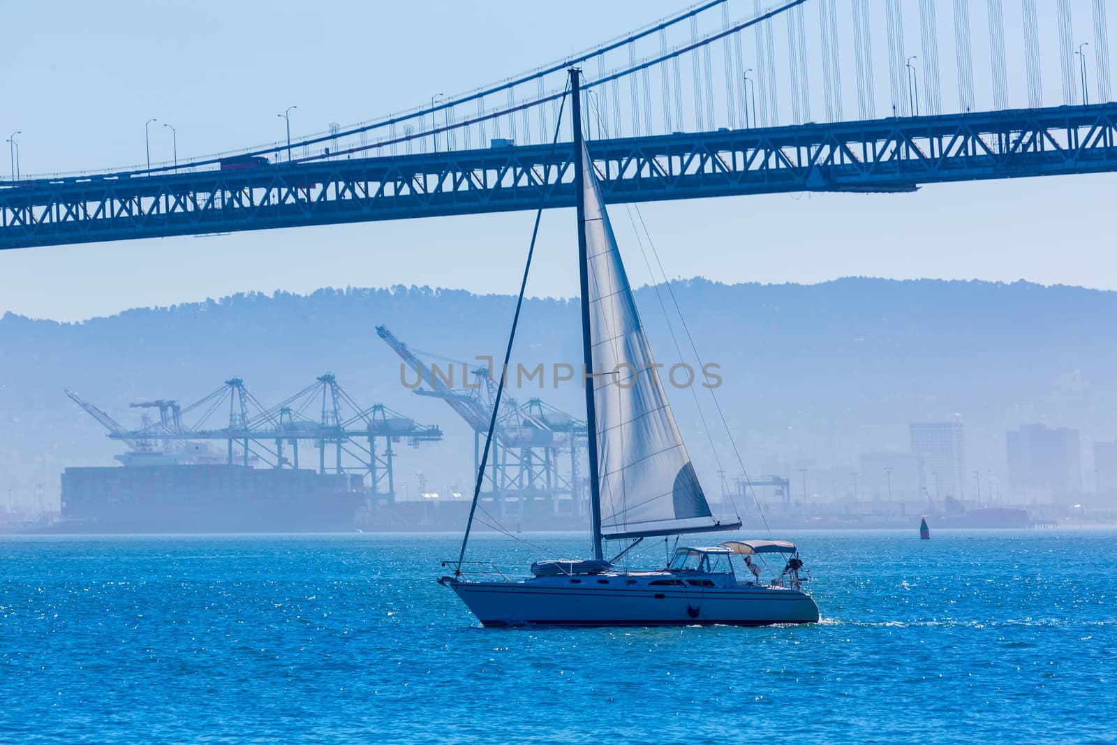 San Francisco Bay bridge sailboat from Pier 7 in California USA