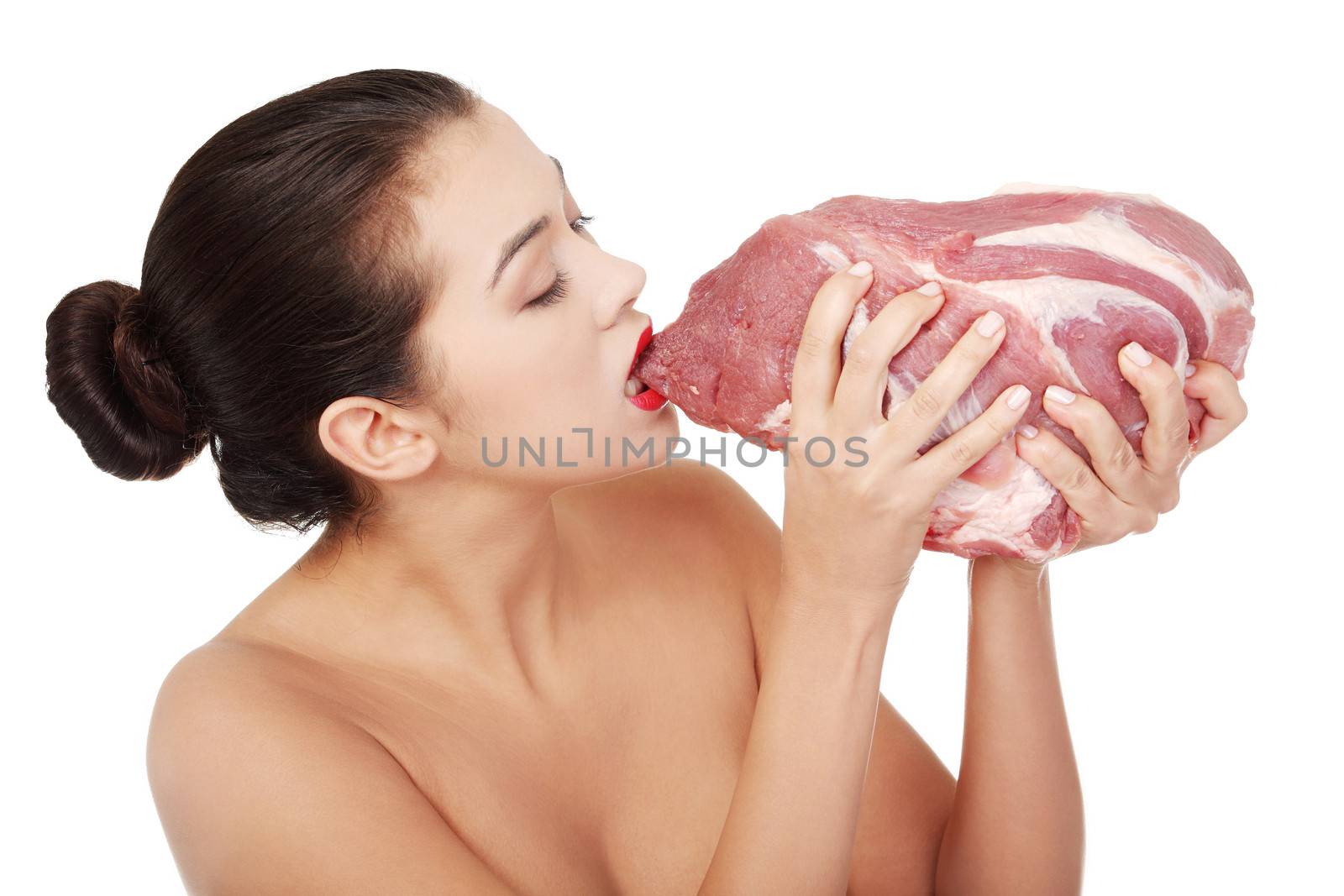 Young beautiful woman eating raw meat. by BDS