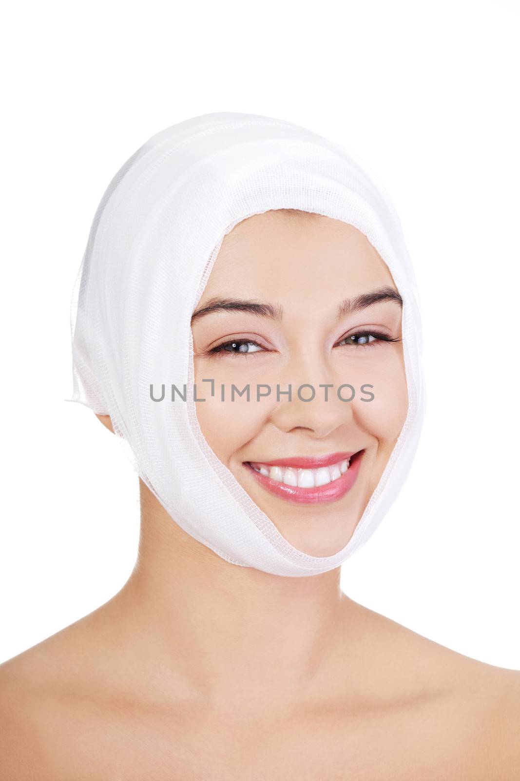 Portrait of beautiful young female face with bandage - beauty treatment plastic surgery