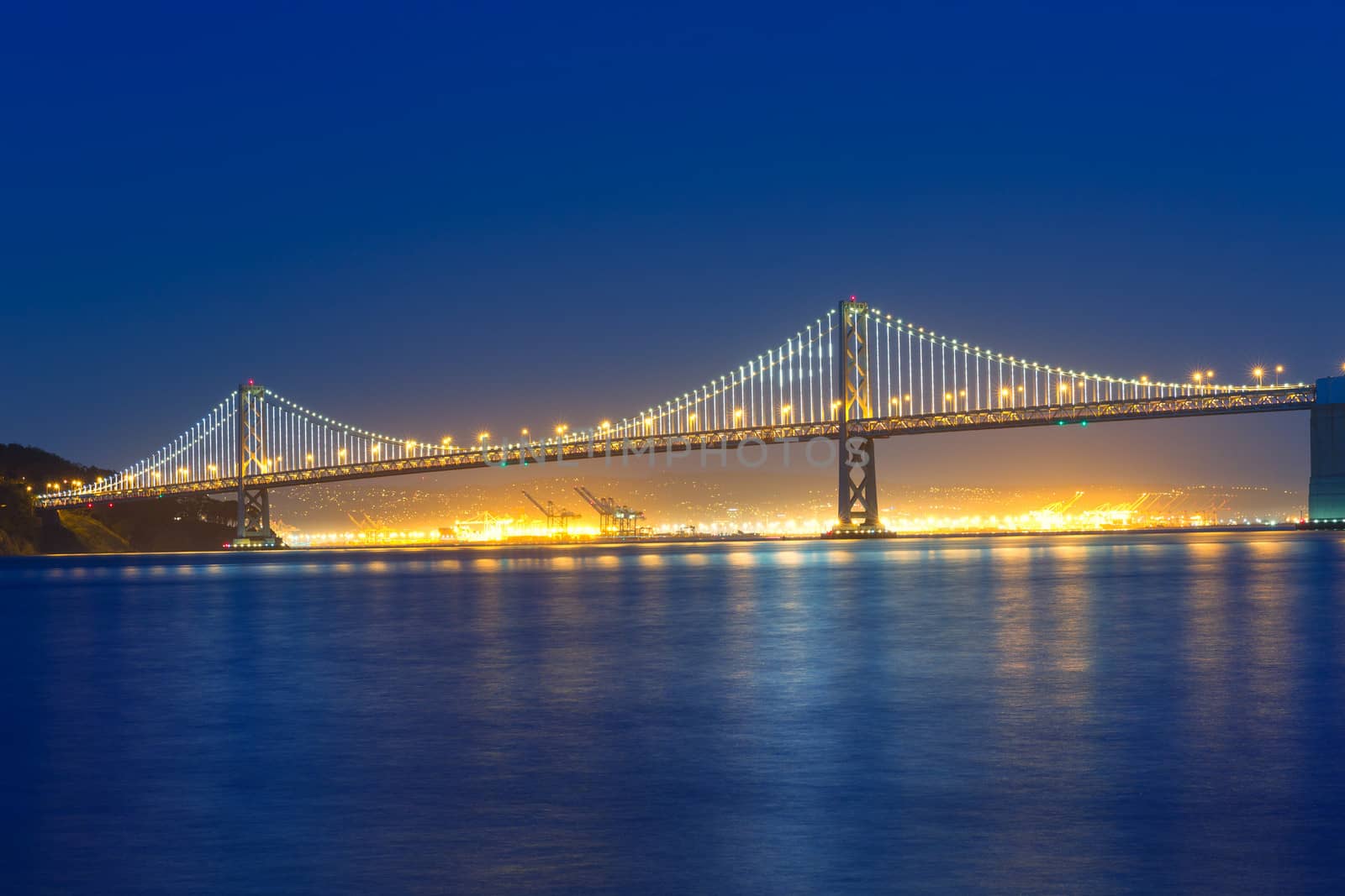 San Francisco Bay Bridge at sunset from Pier 7 California by lunamarina