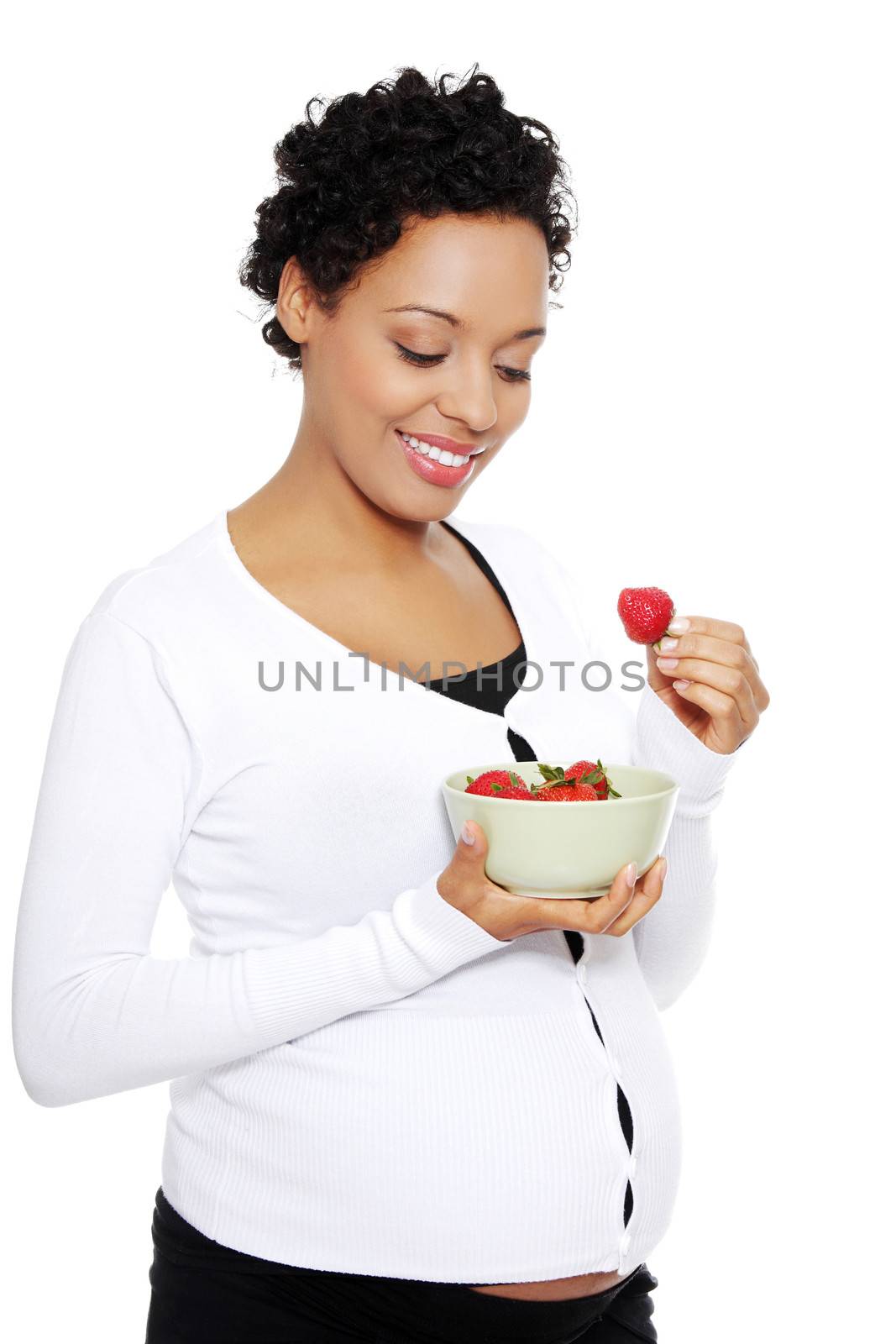 Portrait of a beautifyl young woman eating strawberries, isolated on a white background.