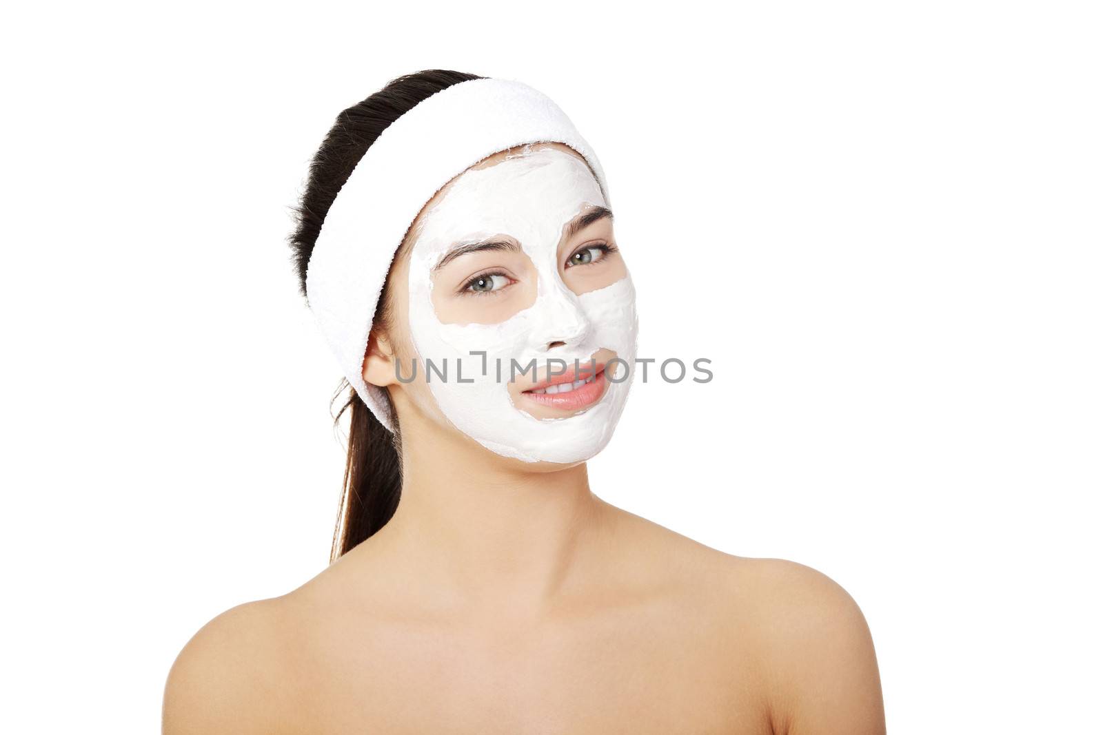 Beautiful woman with clay facial mask, isolated on white