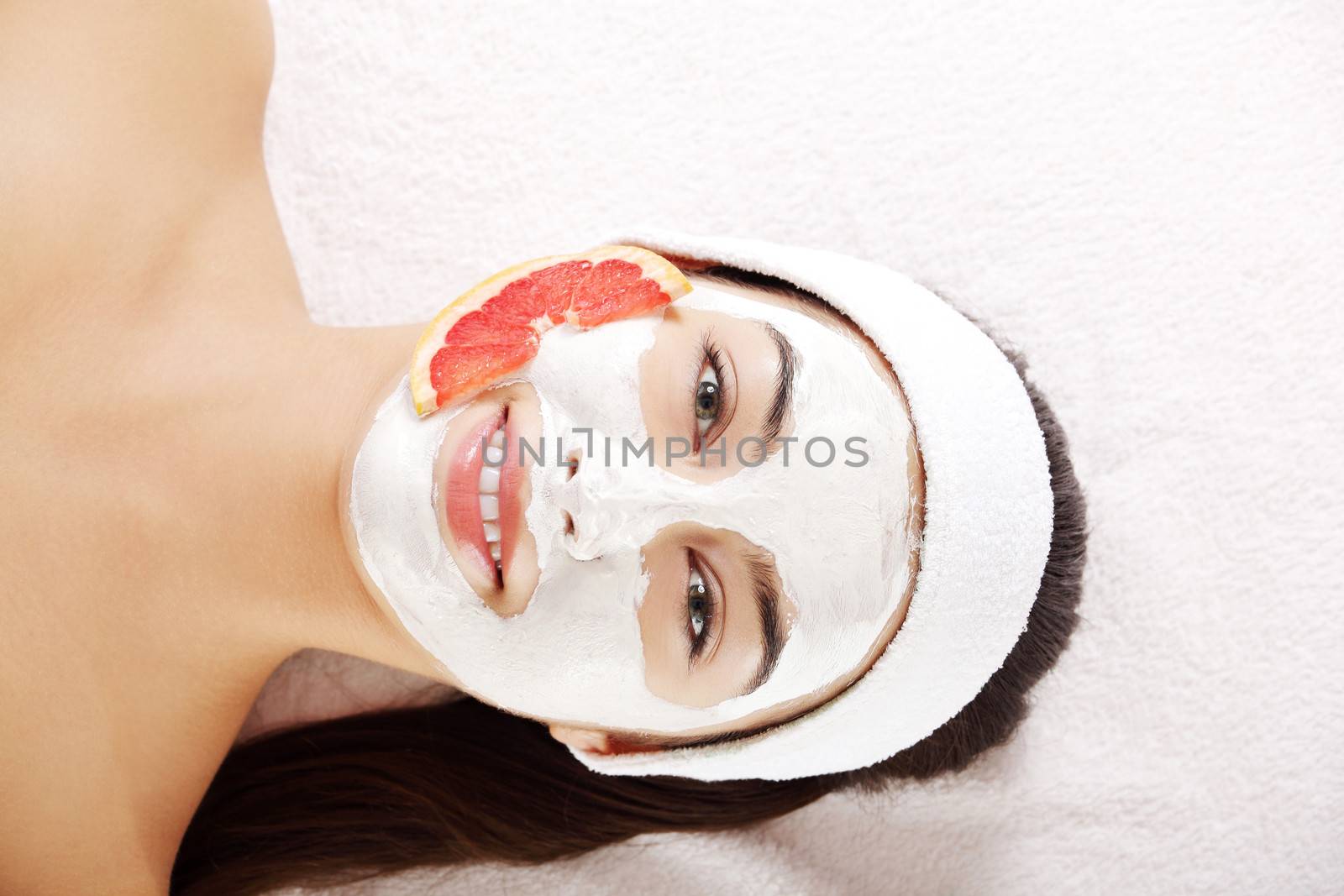 Attractive young woman with fruit mask by BDS