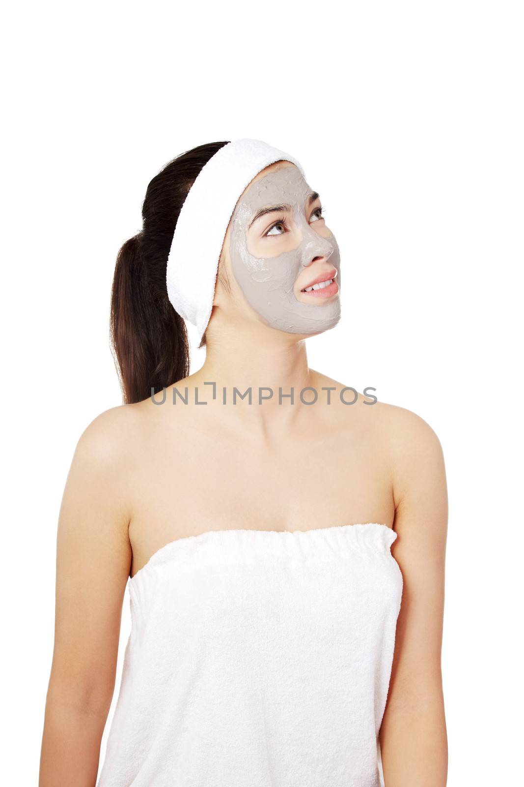 Beautiful woman with clay facial mask, isolated on white