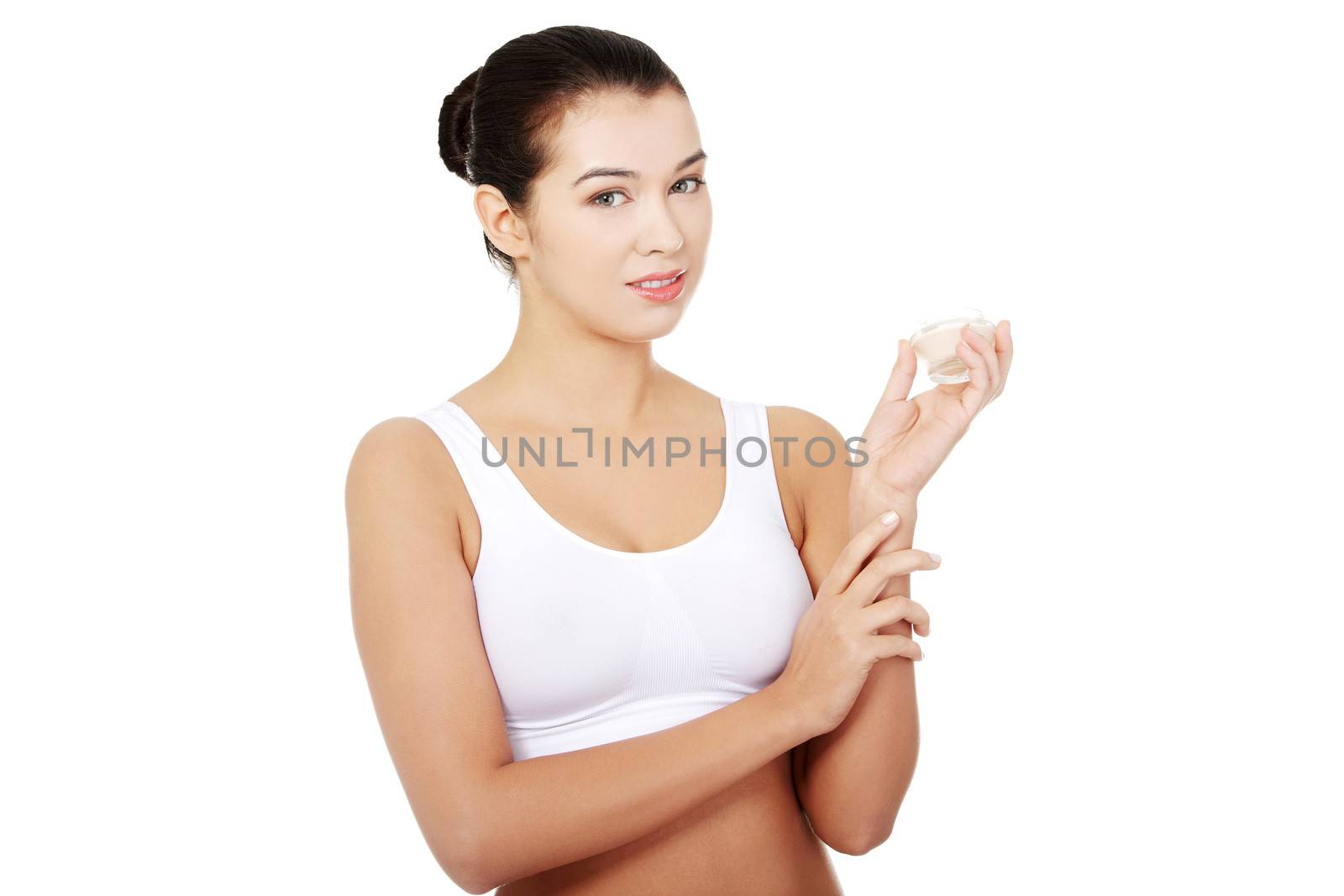 Pretty fit woman in underwear with moisturizer cream. Isolated on white background