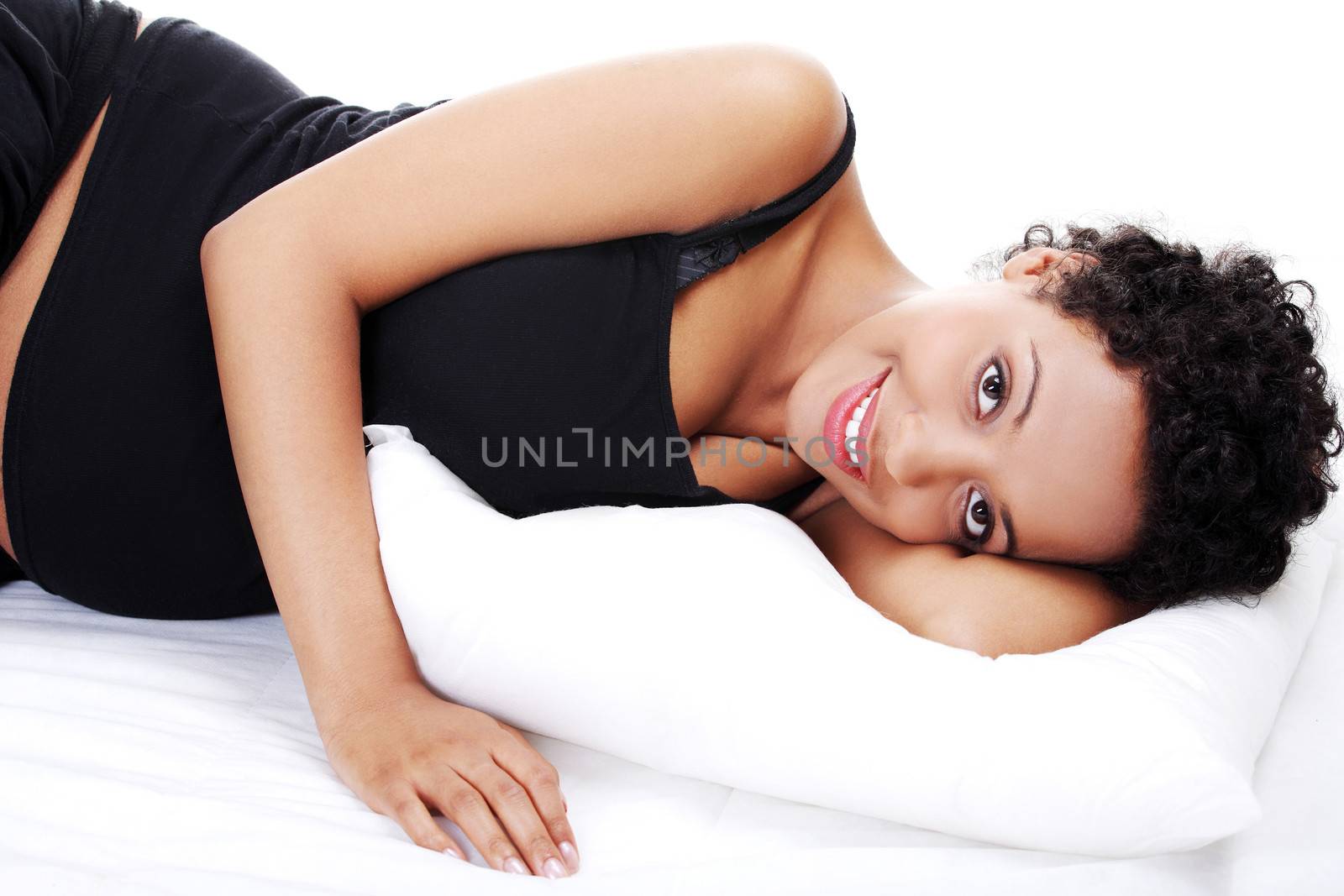 Pregnant woman sleeping on her bed