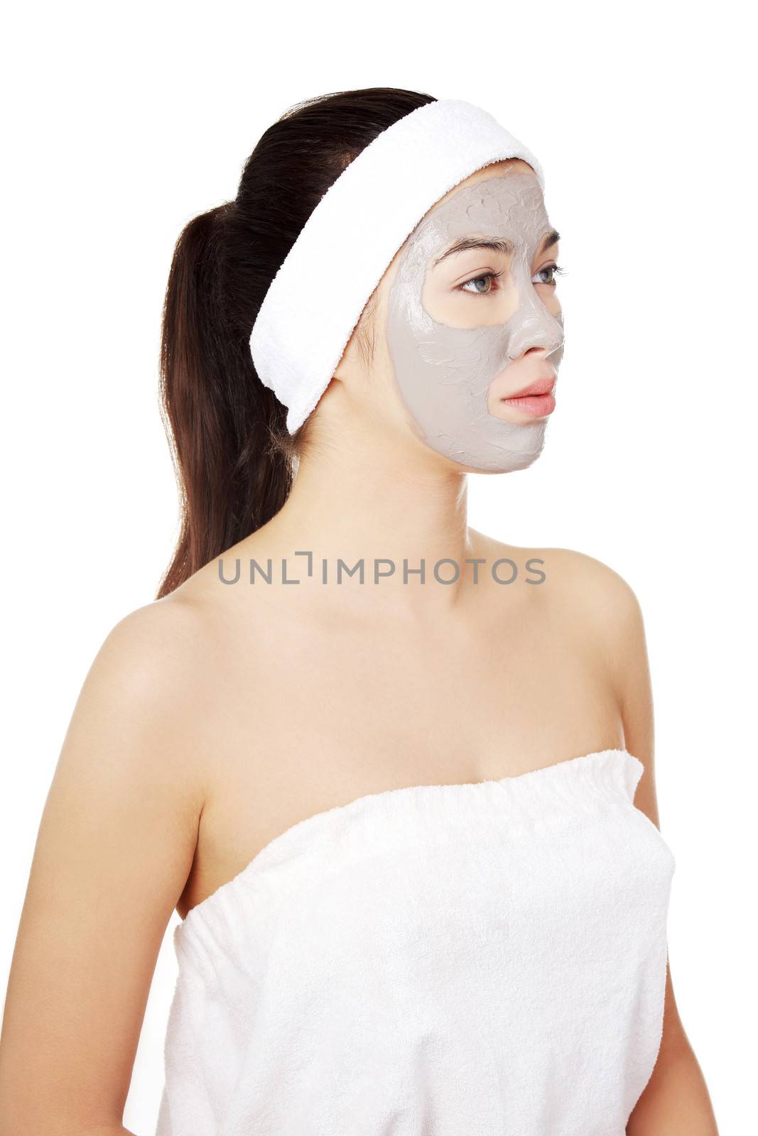 Beautiful woman with clay facial mask, isolated on white