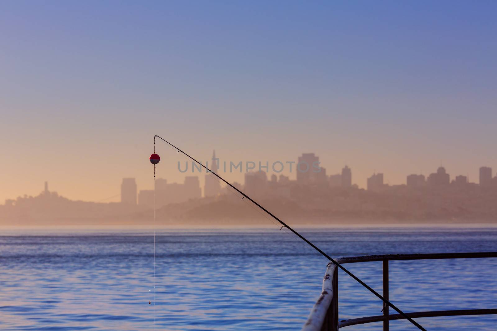 San francisco fog skyline with fishing rod in the mist Californi by lunamarina