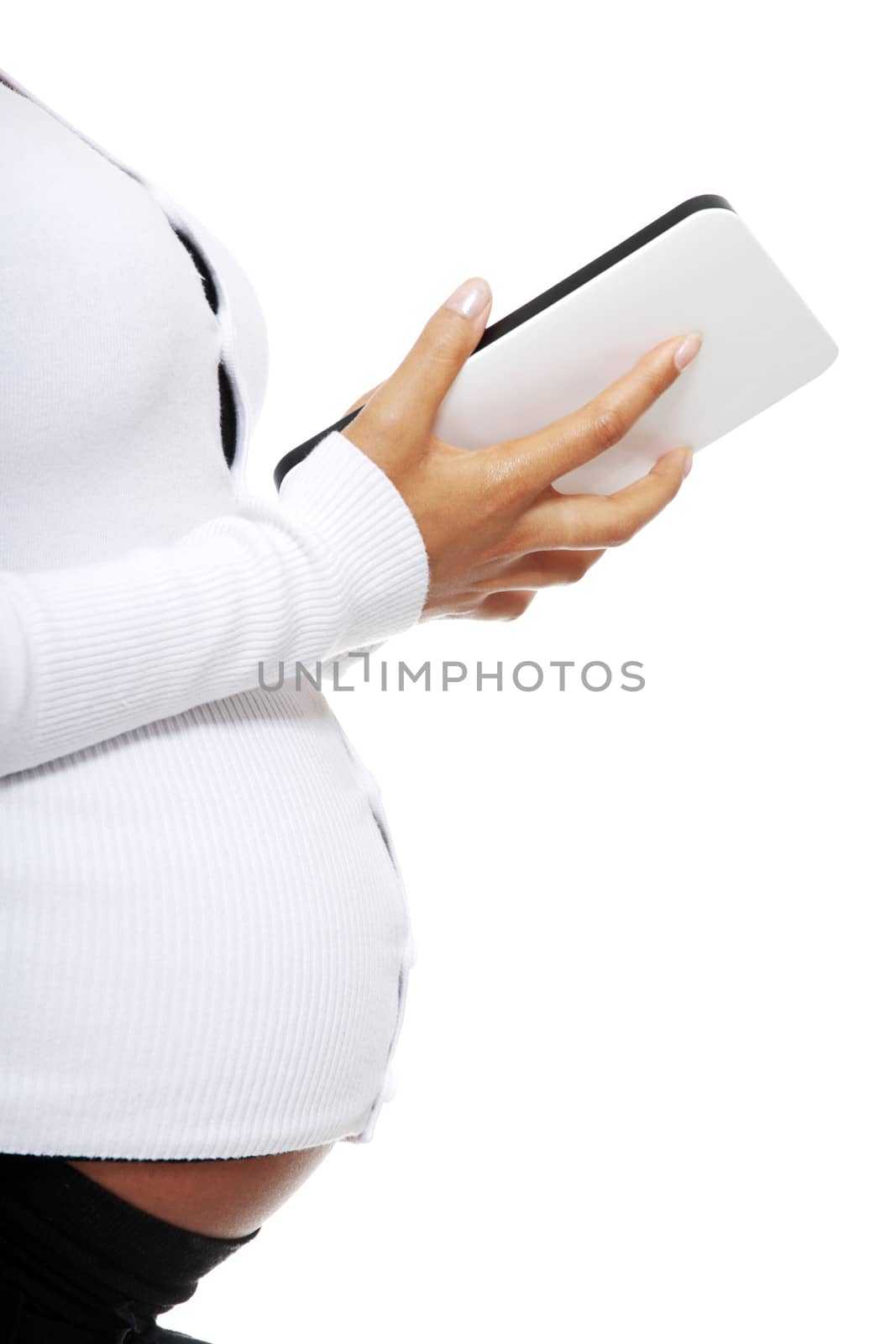 Pregnant woman relaxing with a computer tablet , isolated on white