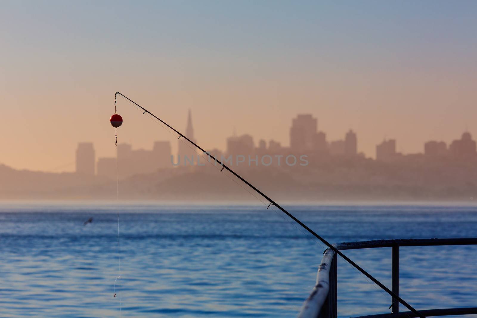 San francisco fog skyline with fishing rod in the mist Californi by lunamarina