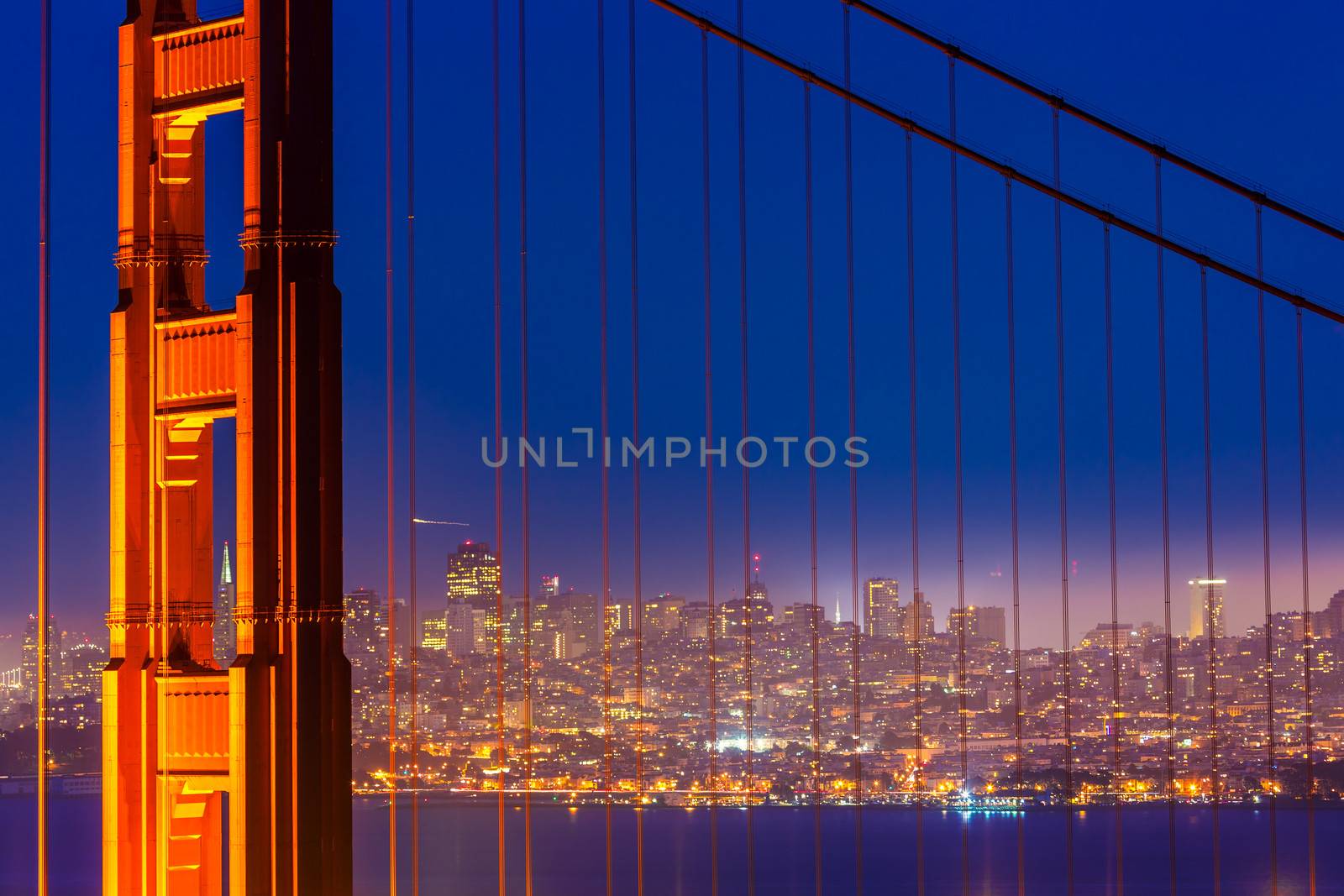 San Francisco Golden Gate Bridge sunset through cables by lunamarina