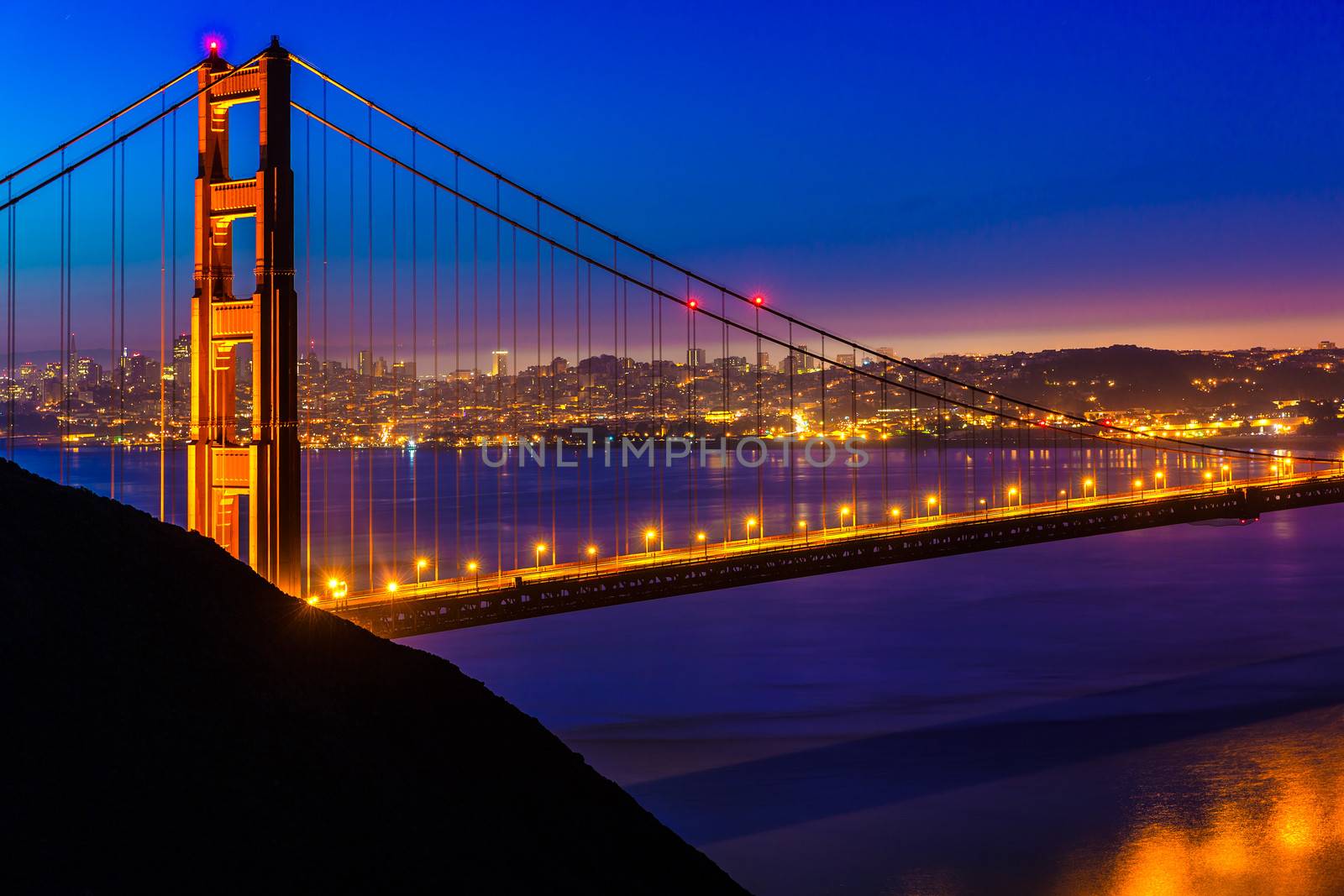 San Francisco Golden Gate Bridge sunset through cables by lunamarina