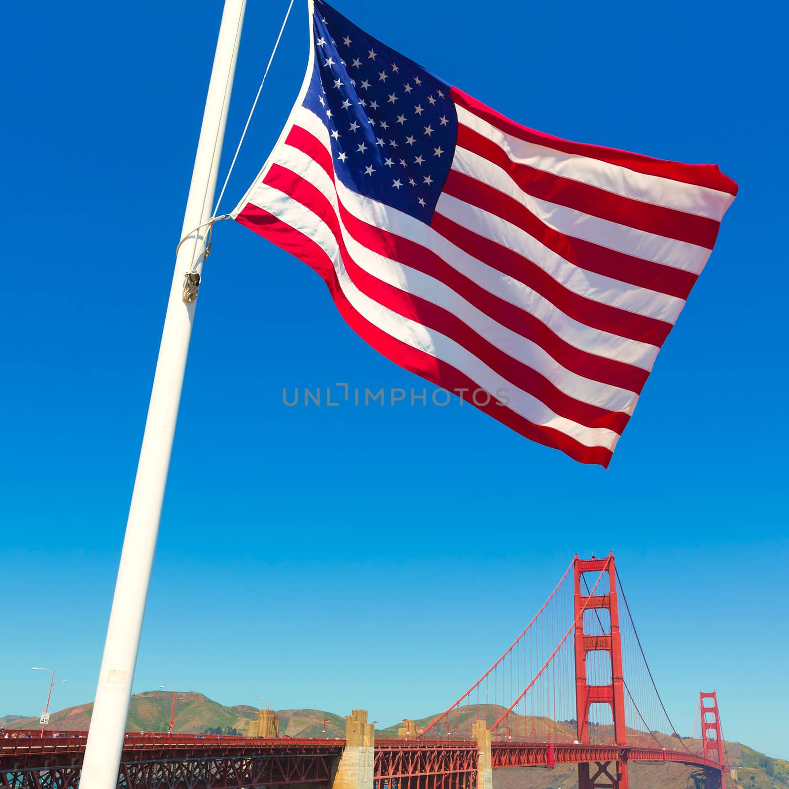 Golden Gate Bridge with United States flag in San Francisco California USA