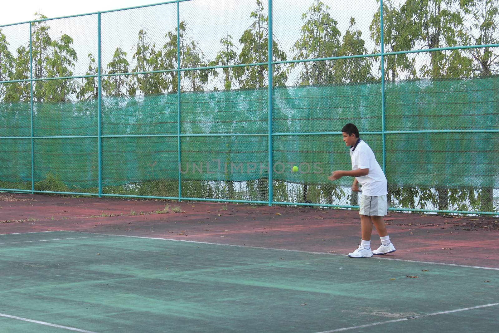 Thai young tennis player hit the tennis ball