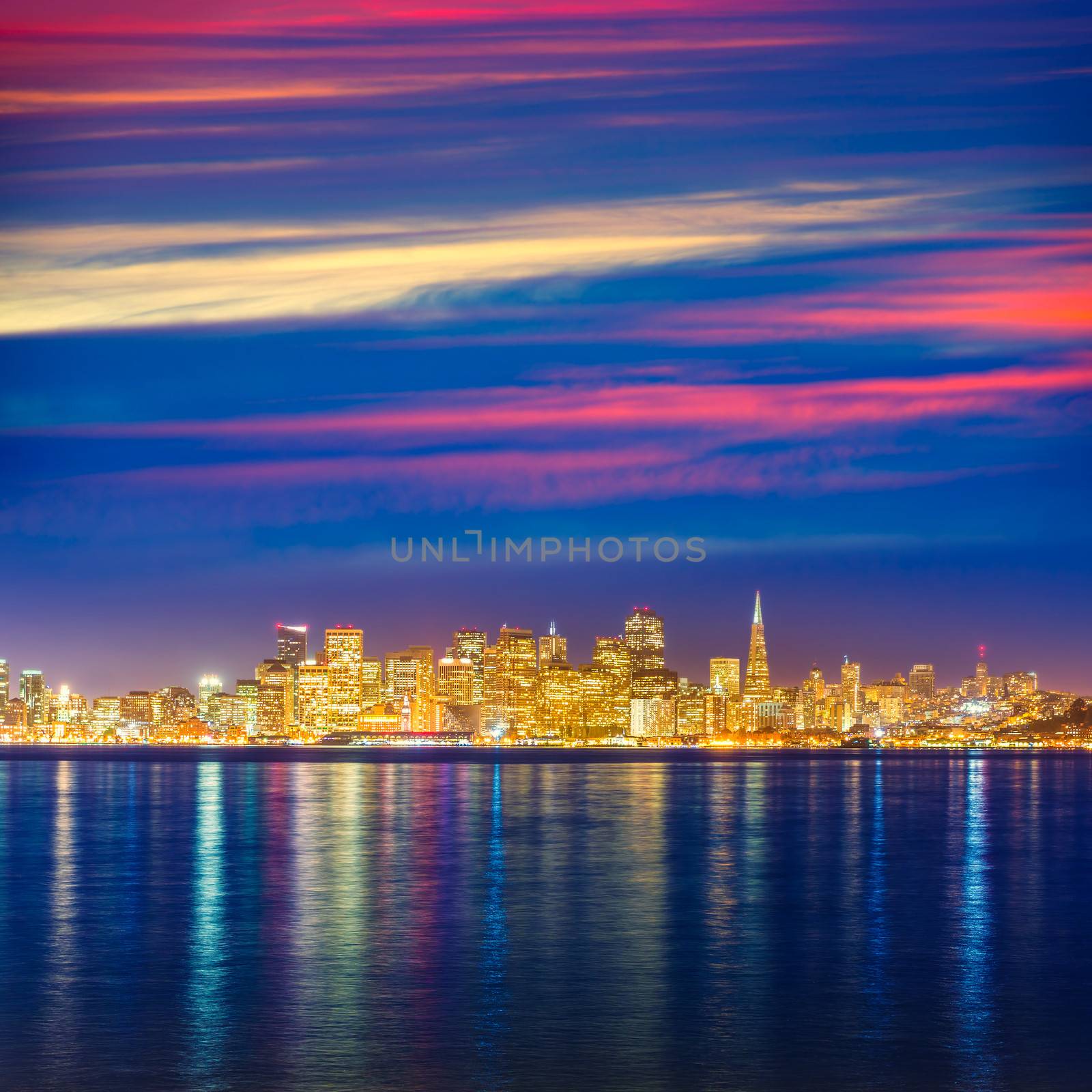 San Francisco sunset skyline in California with reflection in bay water USA