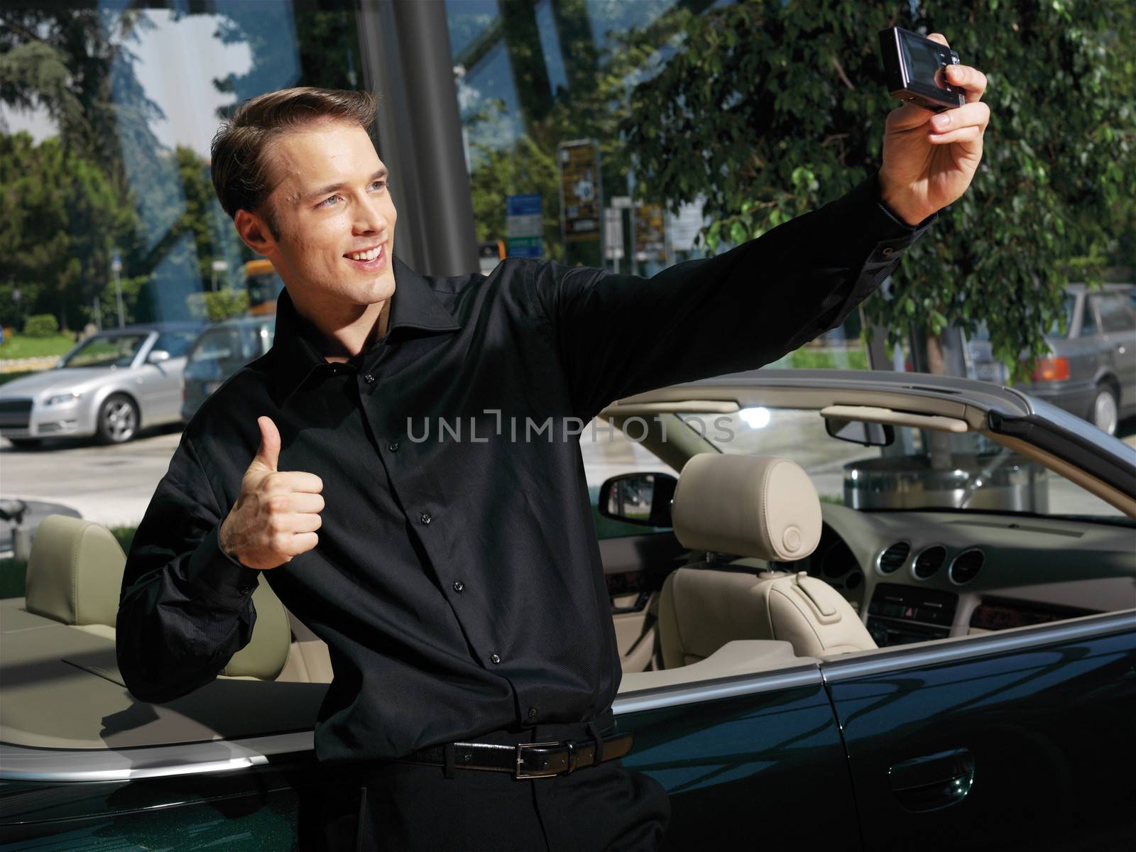 Portrait of a Handsome young guy taking photo with cellphone