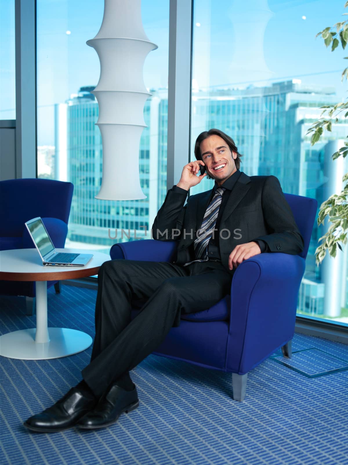 Businessman with laptop in office by toocan