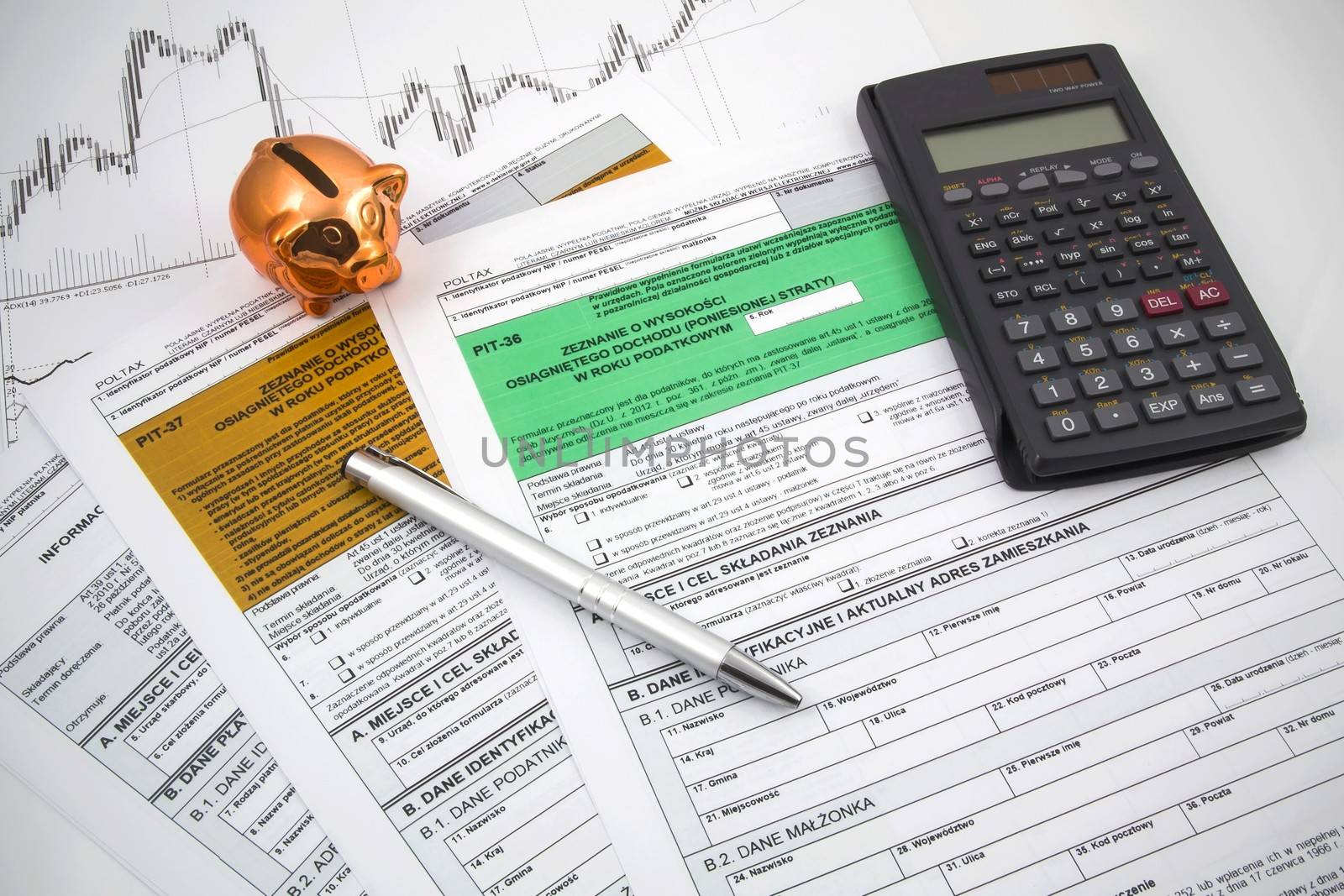 Polish income tax forms with calculator and piggybank by simpson33