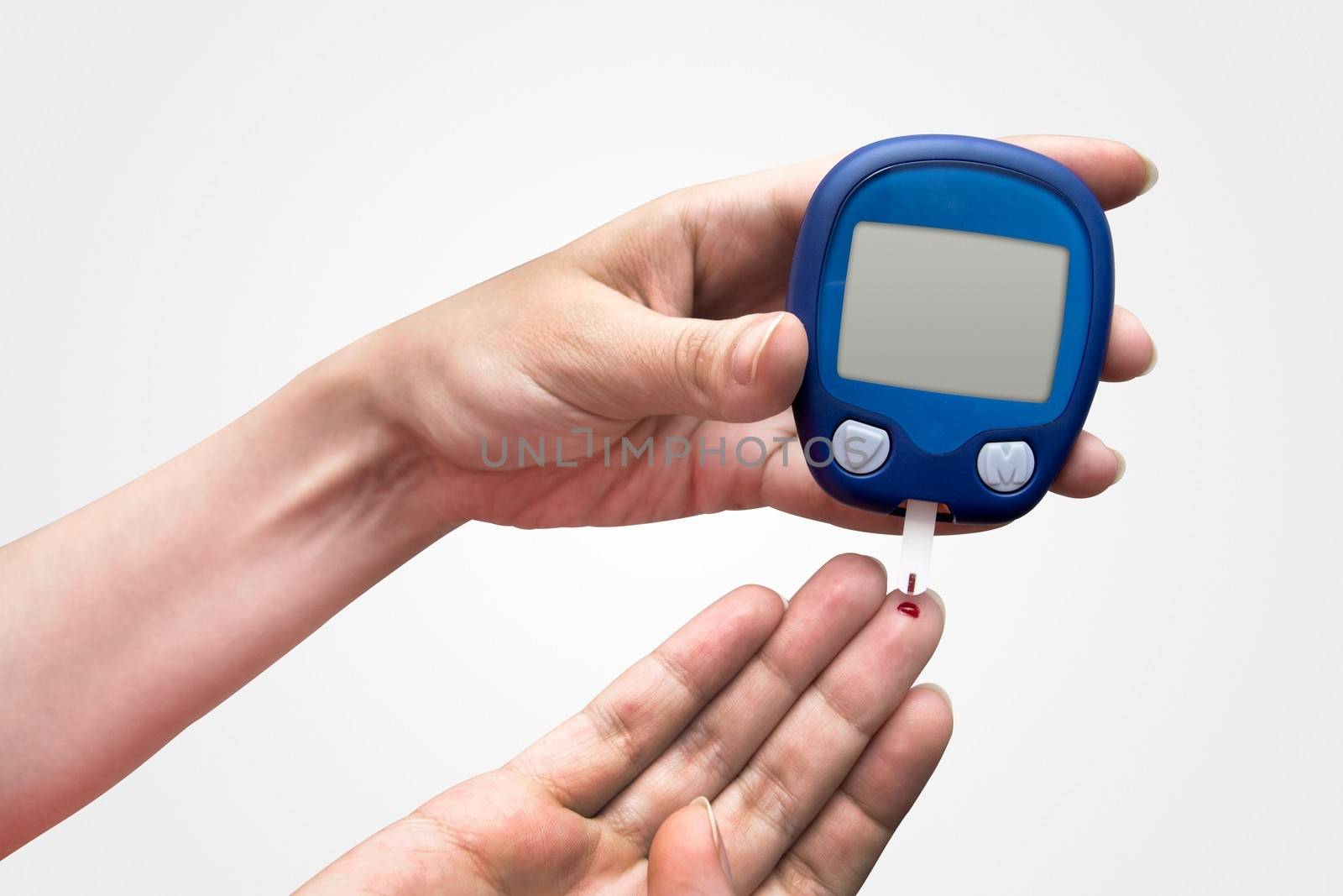 Woman doing blood sugar test by simpson33