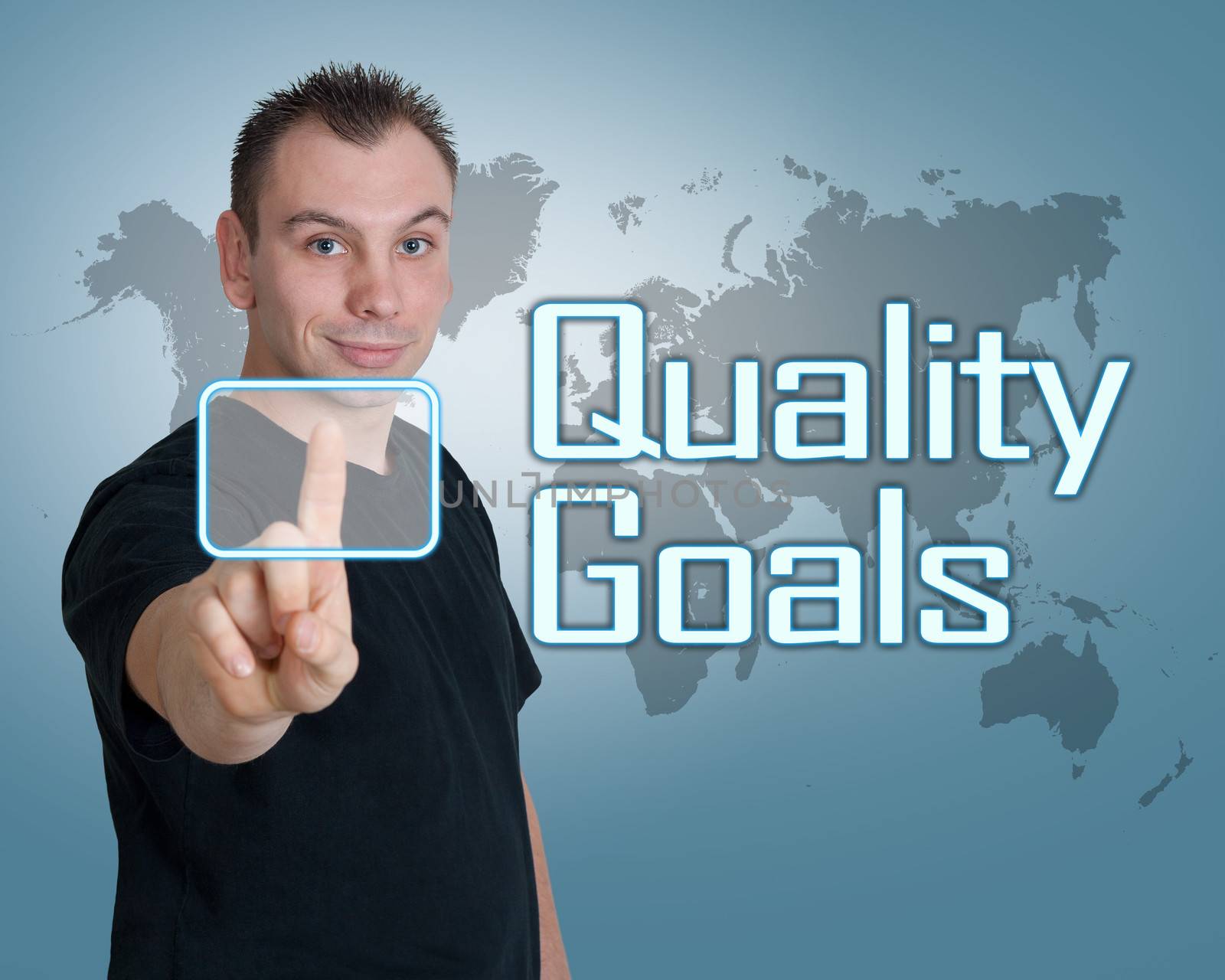 Young man press digital Quality Goals button on interface in front of him