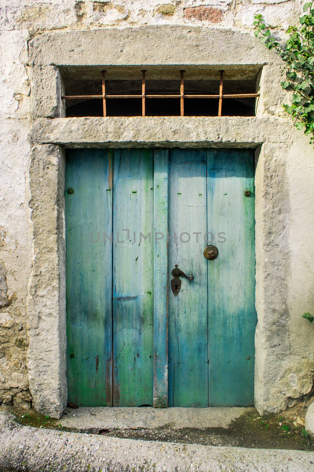 Aged green wooden Door of a farmers house