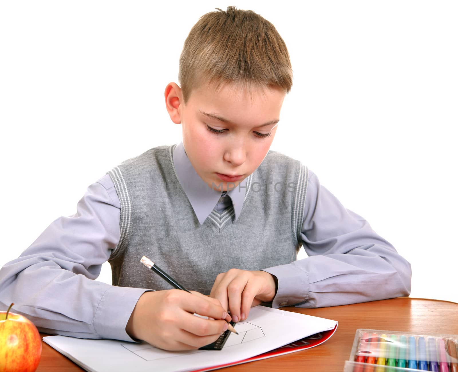 Kid Drawing at the School Desk Isolated on the White Background