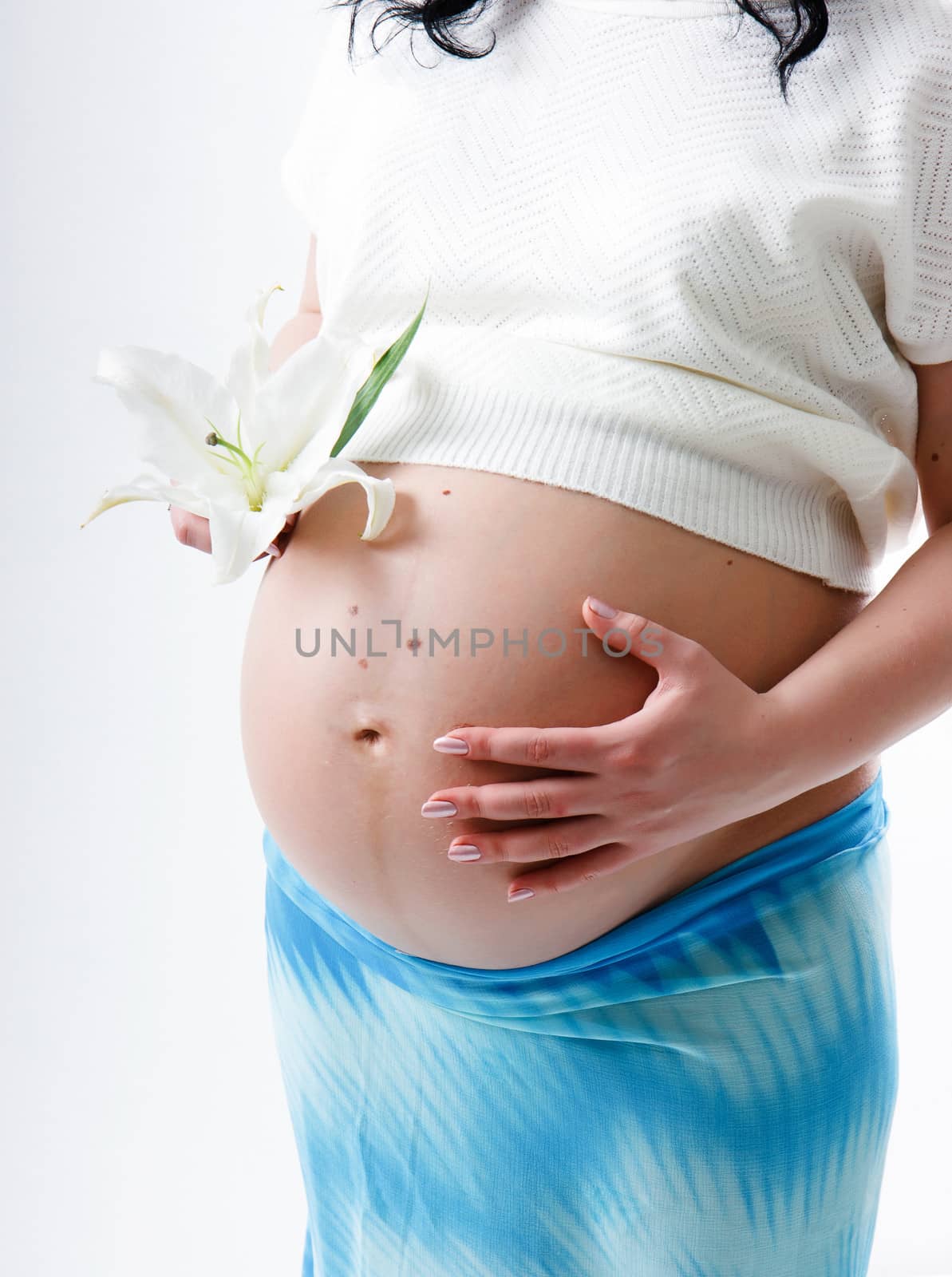 Pregnant young woman with a big belly. standing