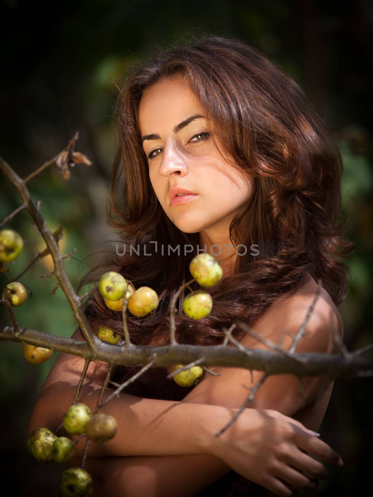 Soft portrait of young woman with wild apples