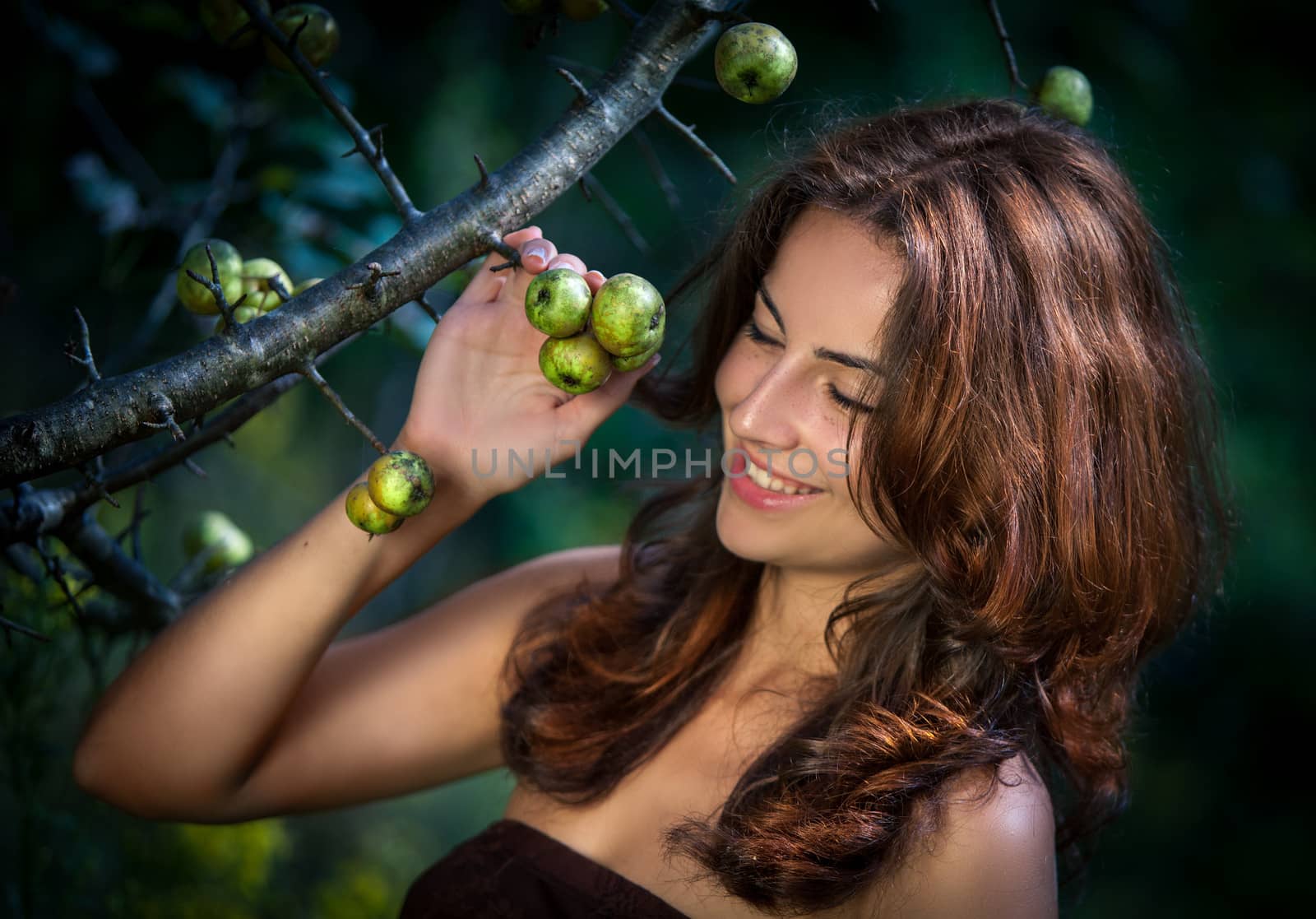 Soft portrait of young woman with wild apples