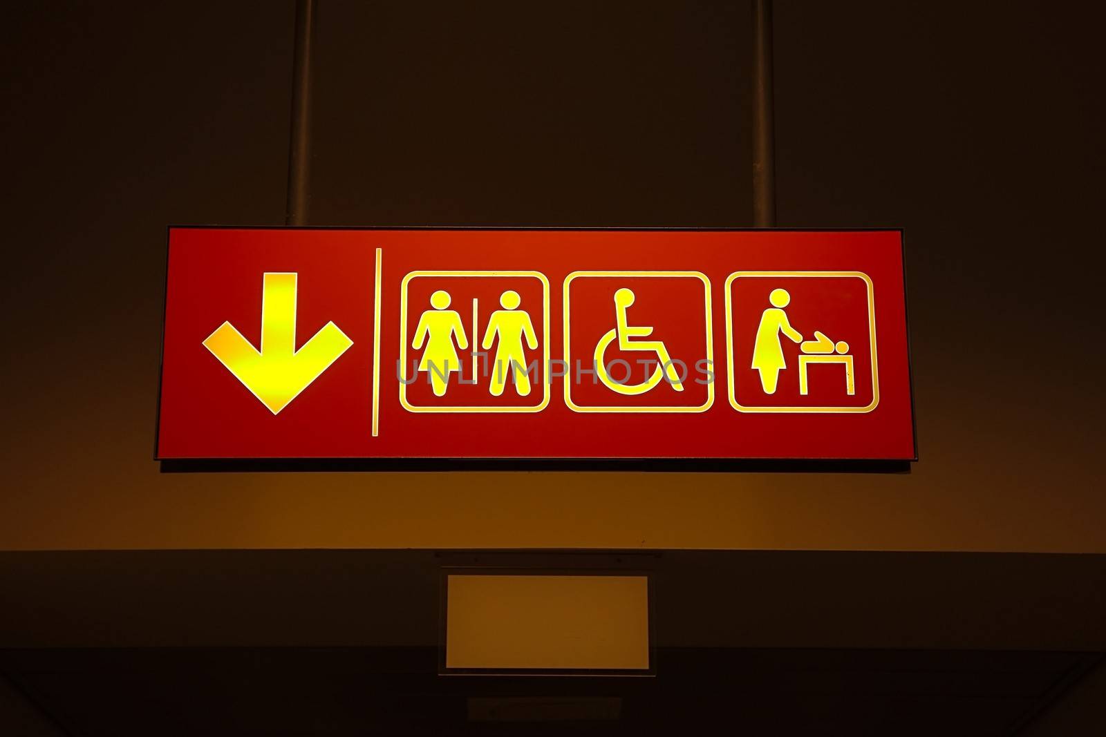 Toilets sign in a building corridor