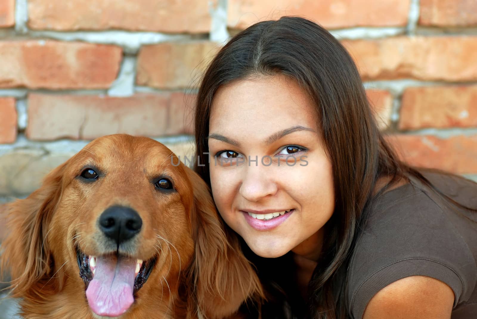 portrait of young caucasian teenage girl with her golden retriever dog