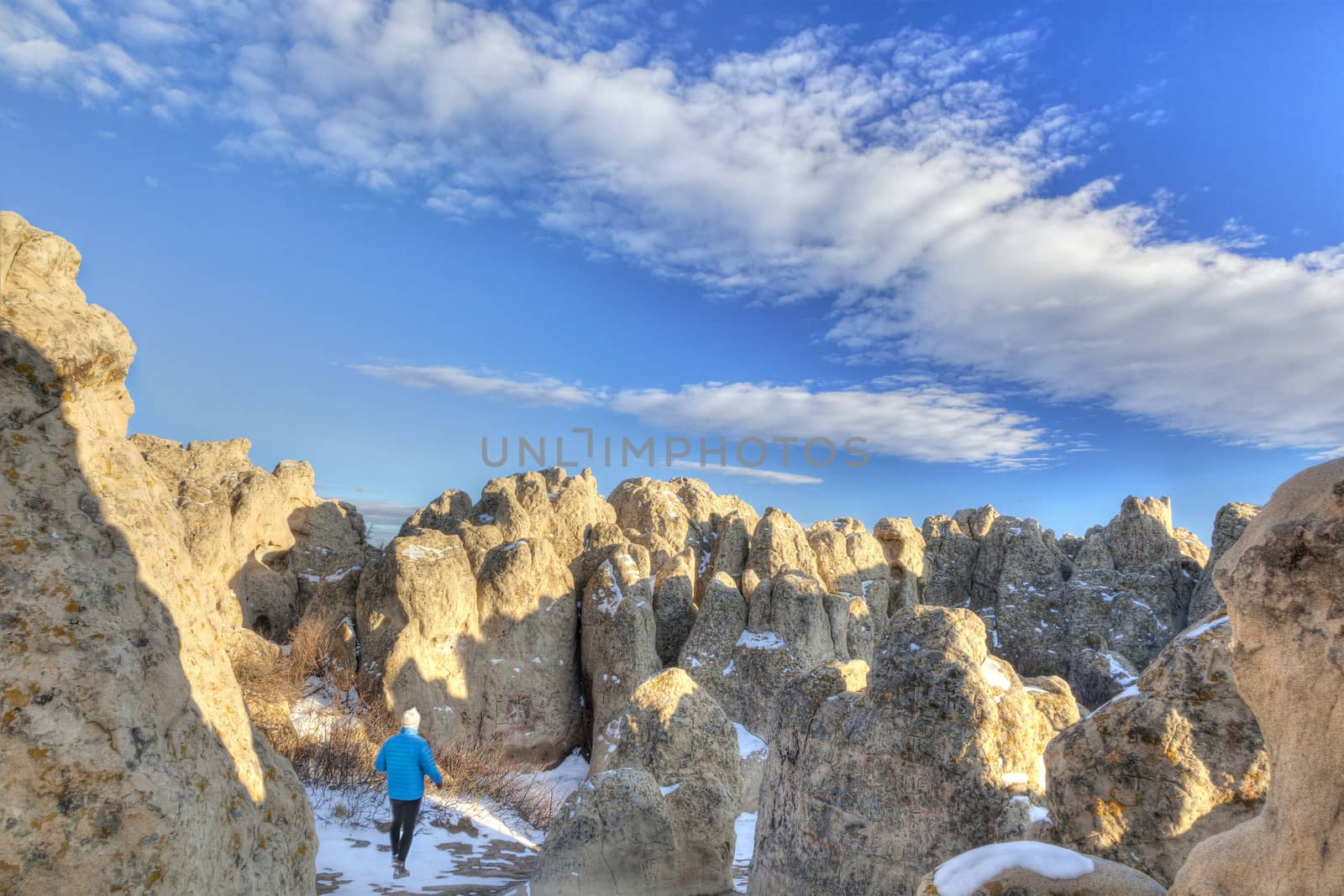 hiker in Natural Fort rock formation by PixelsAway