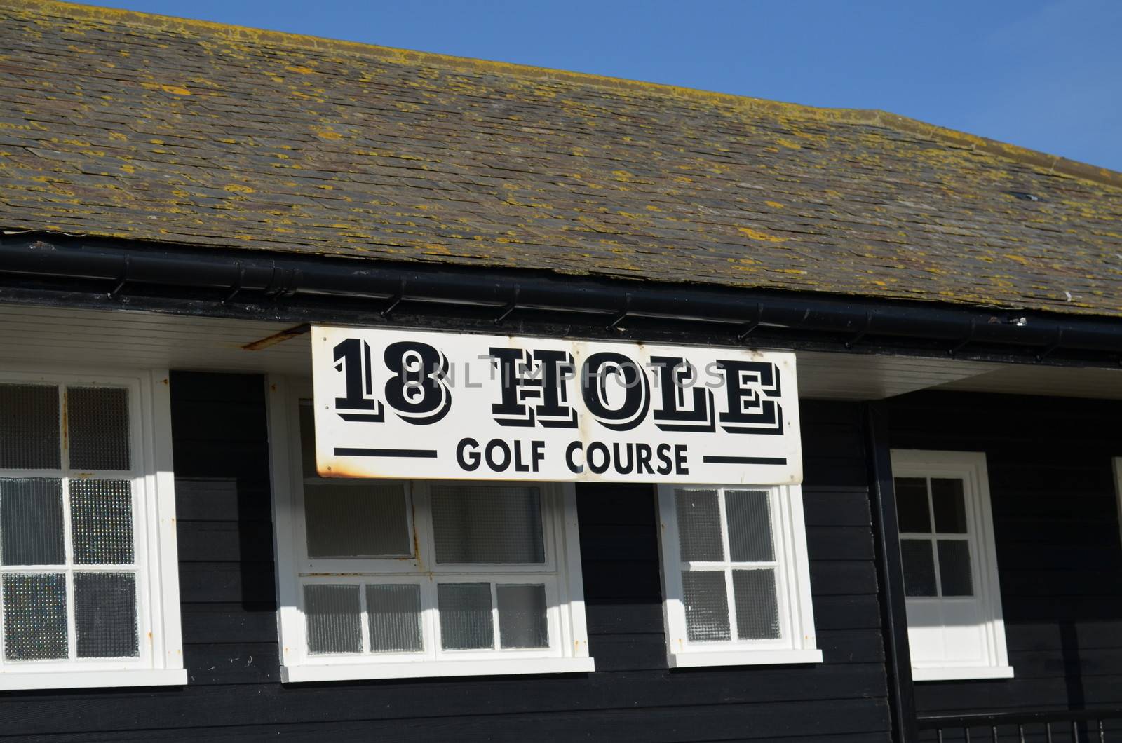 18th hole golf course sign attached to clubhouse.