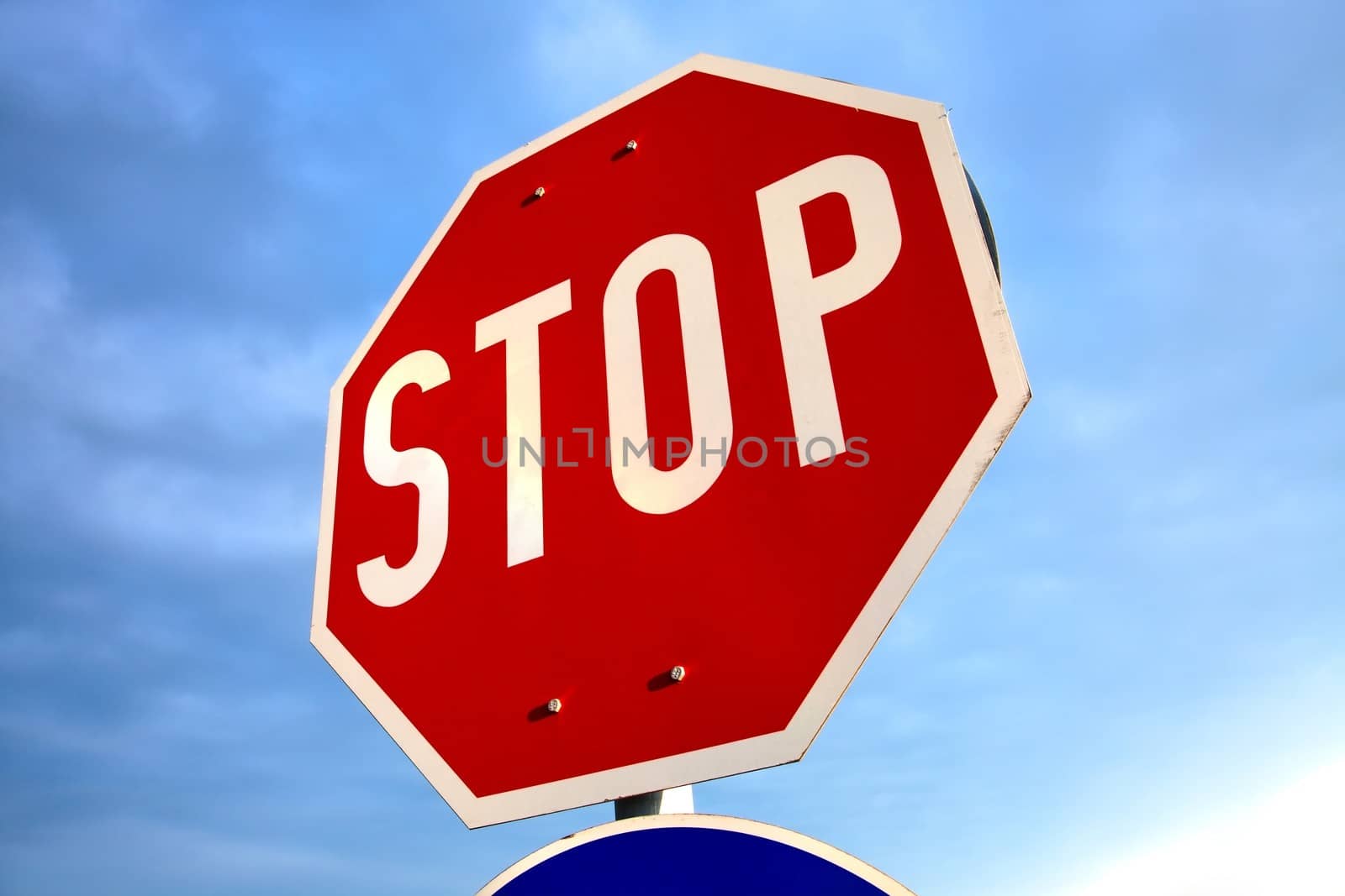 Stop sign against blue sky