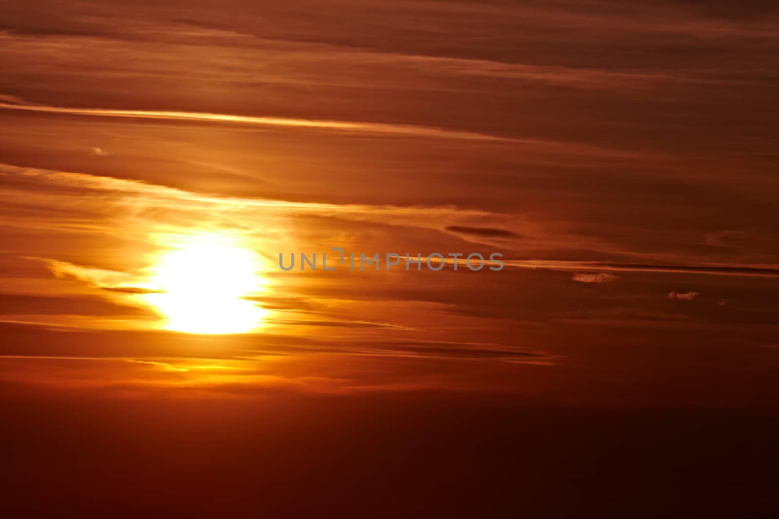 Setting sun in cloudy sky