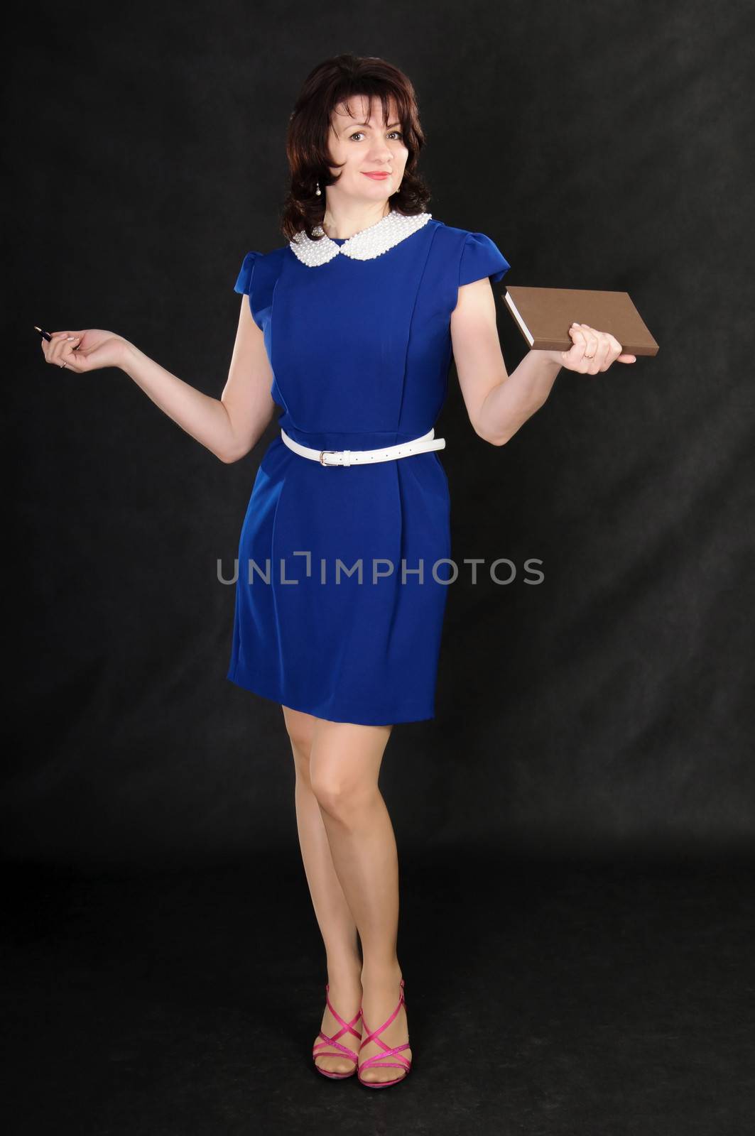 a nice woman in blue dress with pen and notebook