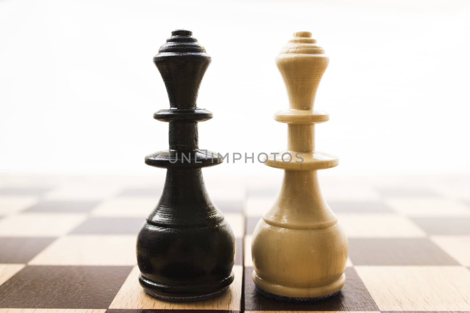 Chess pieces on a board in different compositions.